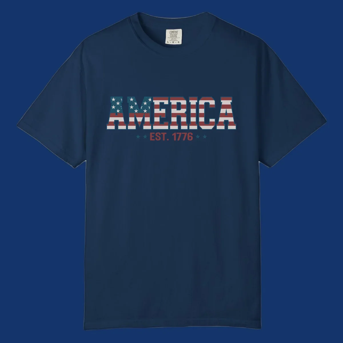 The word AMERICA in block letters, filled with an American flag pattern, above the text EST. 1776 with stars. Concept: america-est-1776-flag.