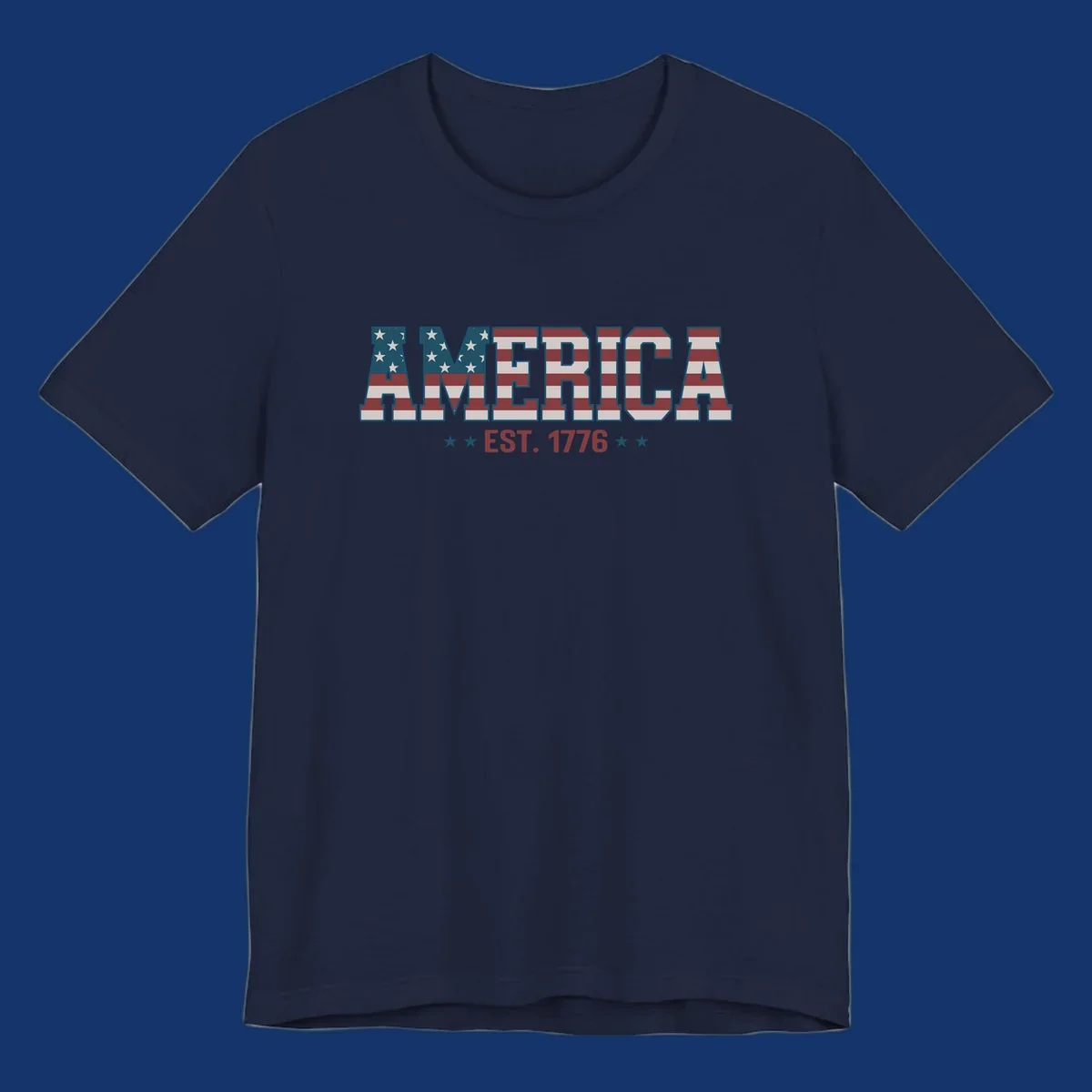 The word AMERICA in block letters, filled with an American flag pattern, above the text EST. 1776 with stars. Concept: america-est-1776-flag.
