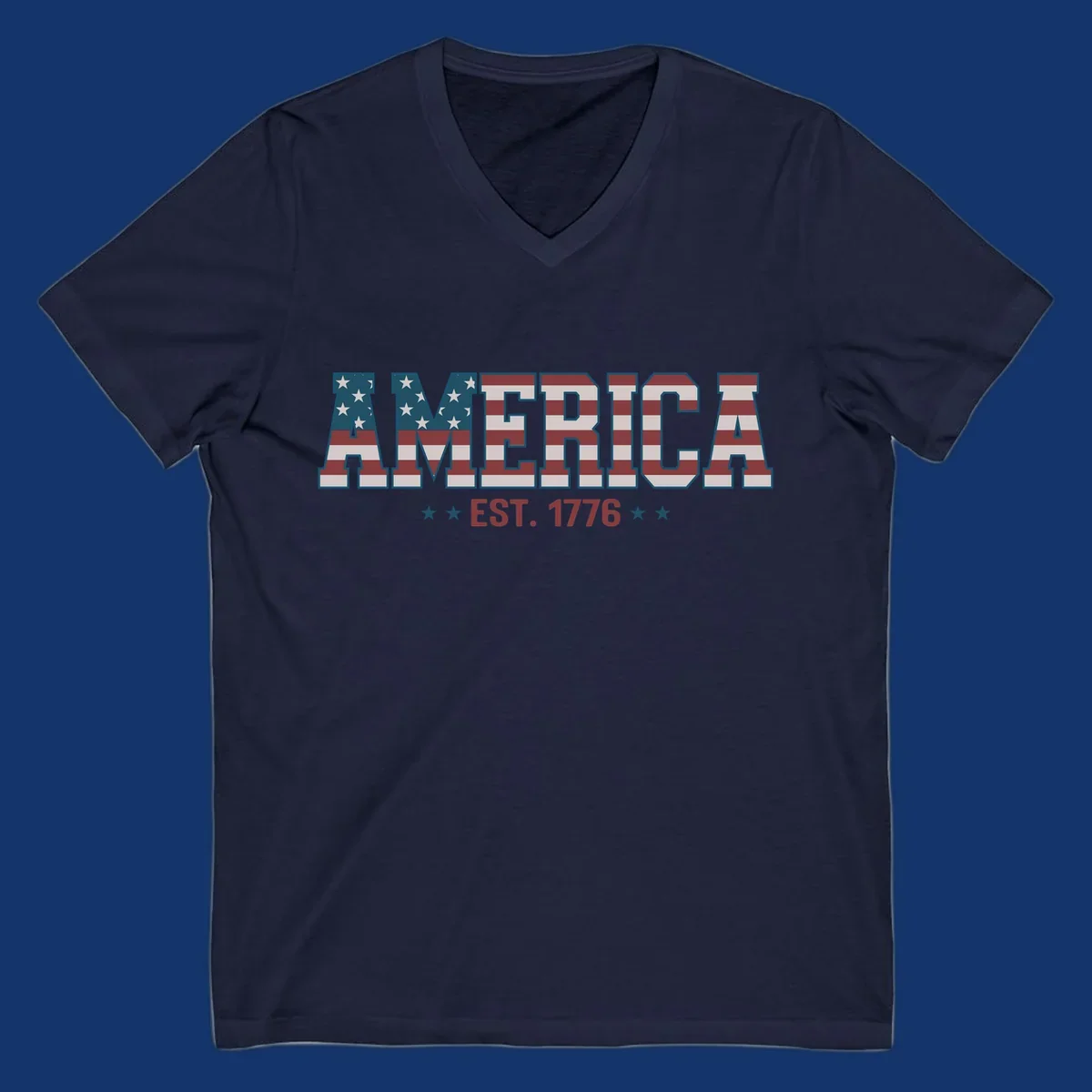 The word AMERICA in block letters, filled with an American flag pattern, above the text EST. 1776 with stars. Concept: america-est-1776-flag.