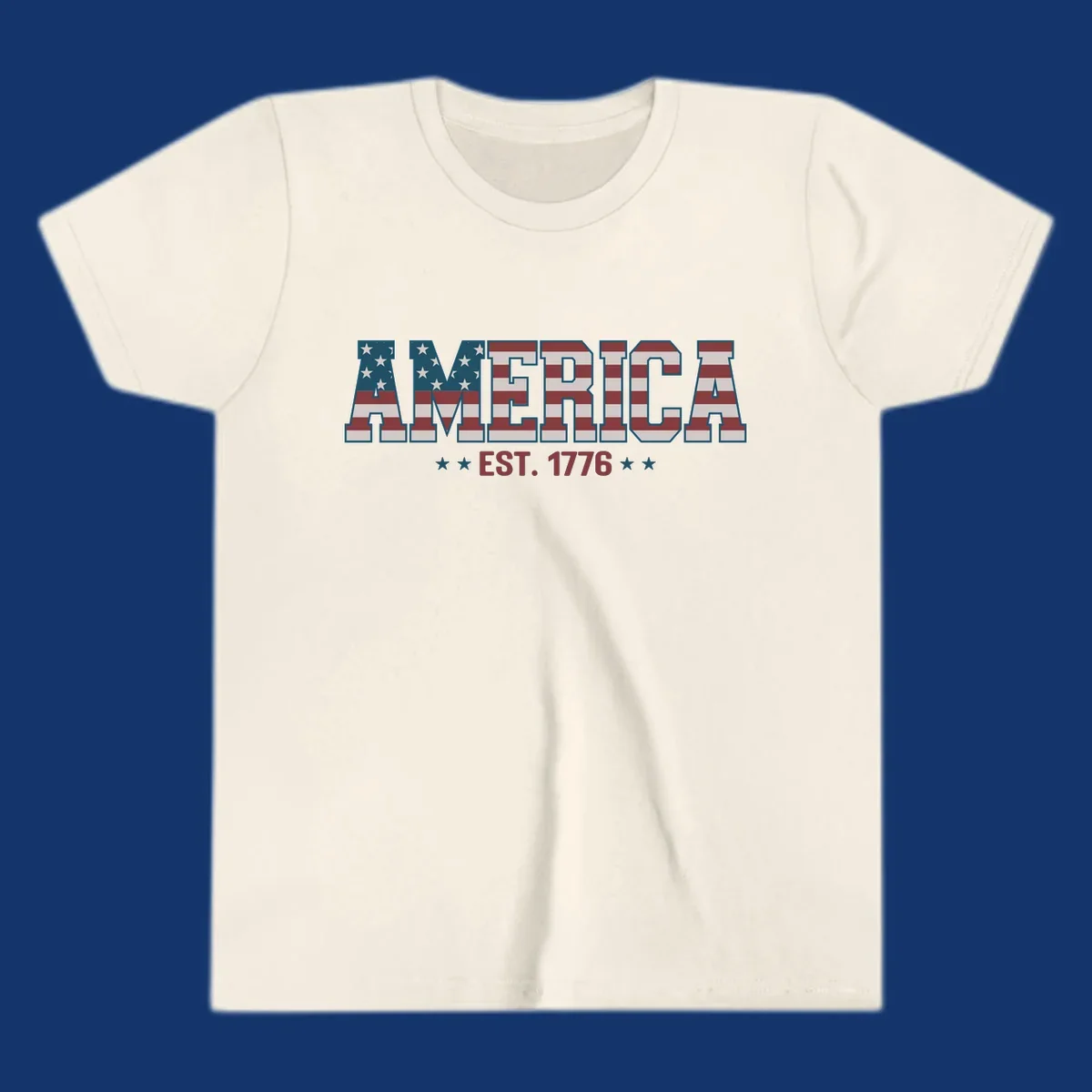 The word AMERICA in block letters, filled with an American flag pattern, above the text EST. 1776 with stars. Concept: america-est-1776-flag.