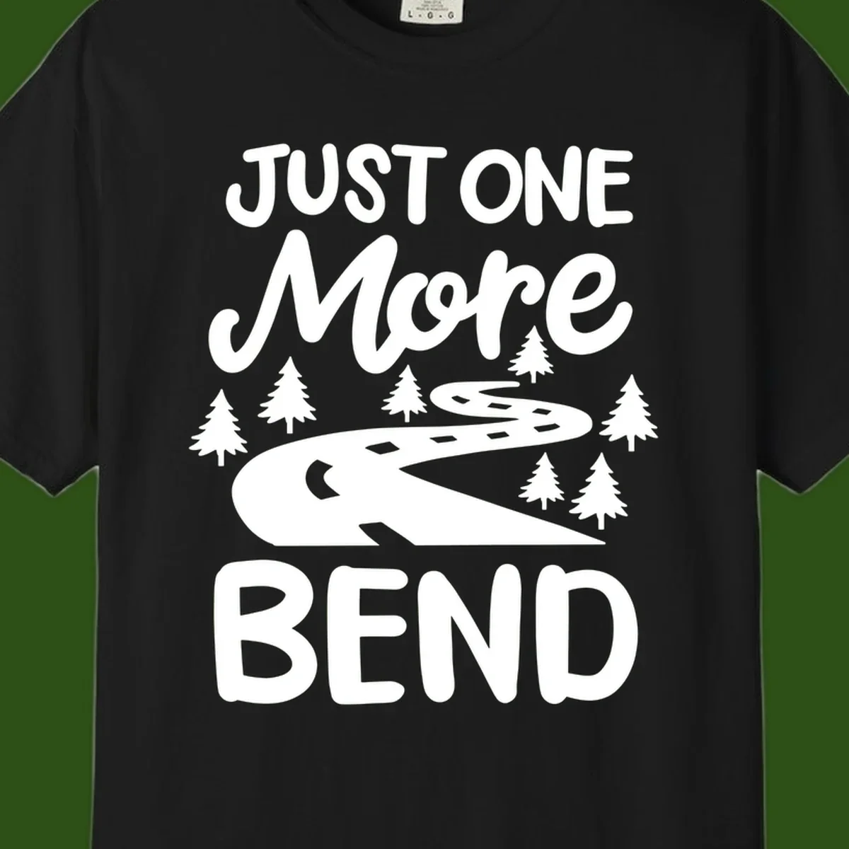 White design on gray background showing a winding road through evergreen trees with cursive text reading 'Just One More Bend'