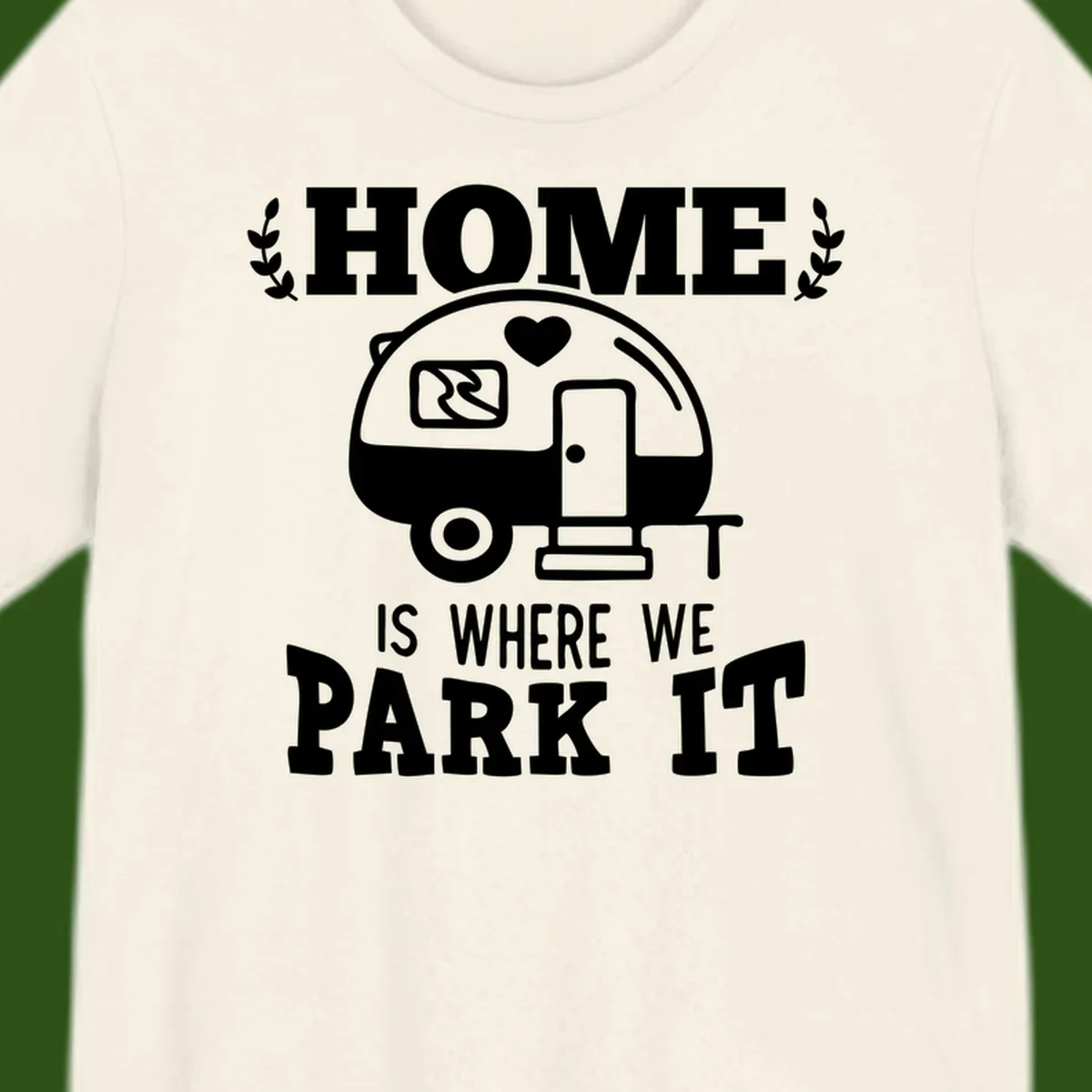 Vintage travel trailer illustration with 'Home Is Where We Park It' text and laurel wreaths on gray background
