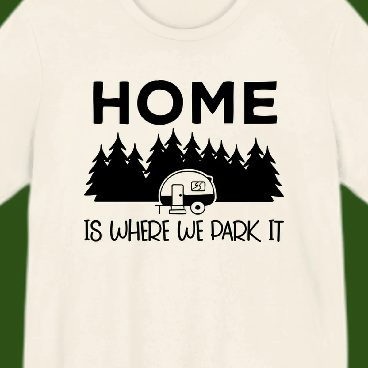 Home is where we park it design with travel trailer and forest trees on gray background