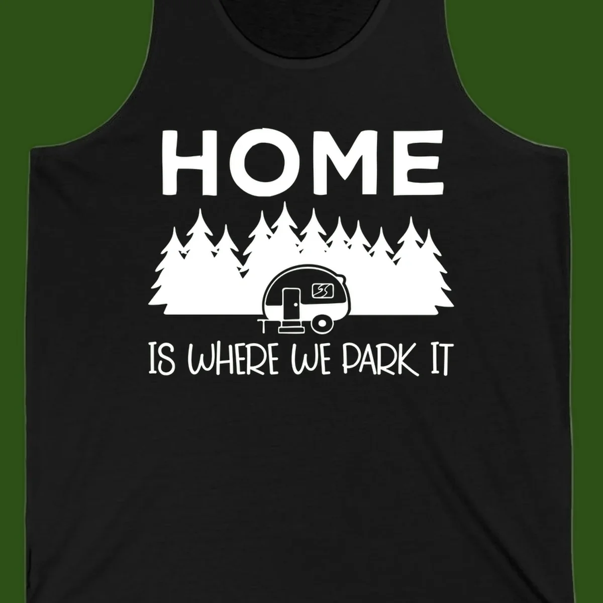 Home is where we park it design with travel trailer and forest trees on gray background