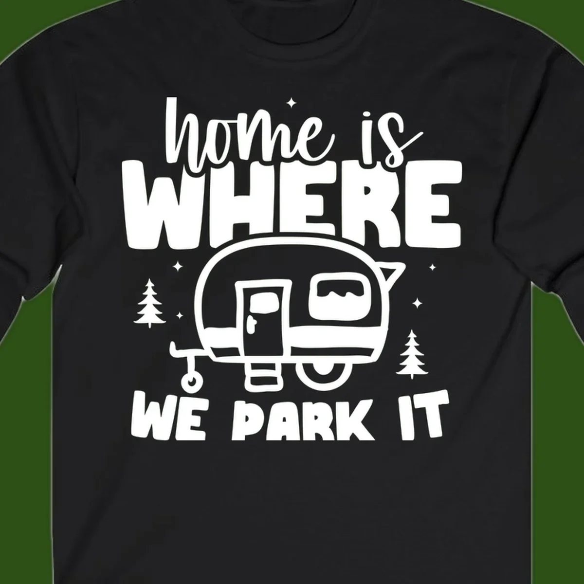 Retro-style design with 'home is where we park it' text and vintage travel trailer illustration surrounded by pine trees and sparkles