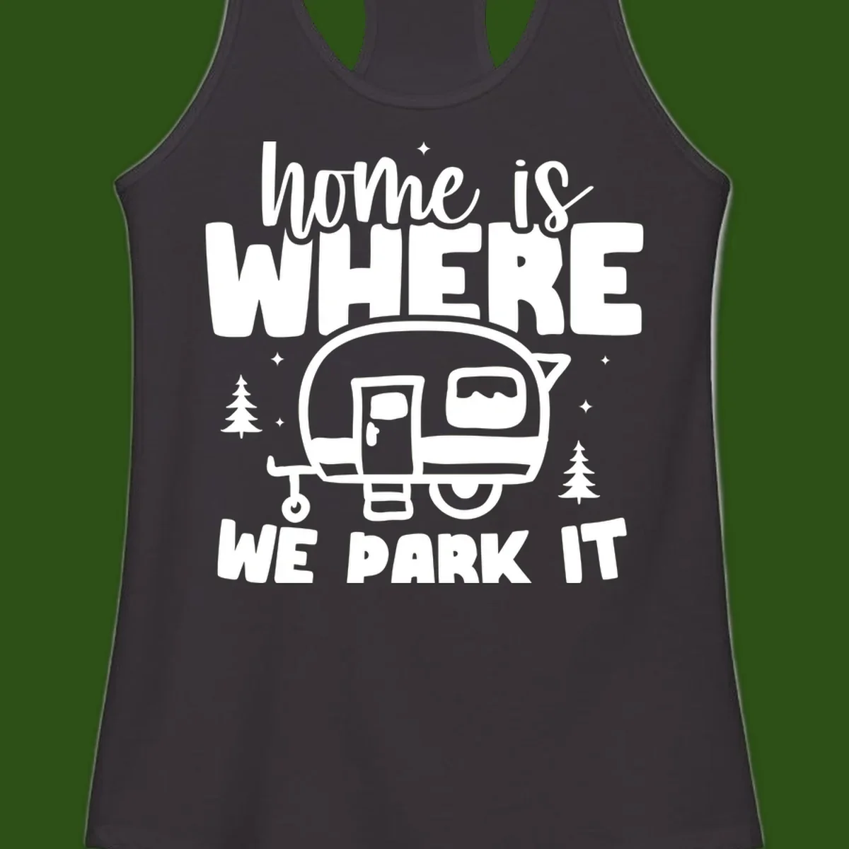 Retro-style design with 'home is where we park it' text and vintage travel trailer illustration surrounded by pine trees and sparkles