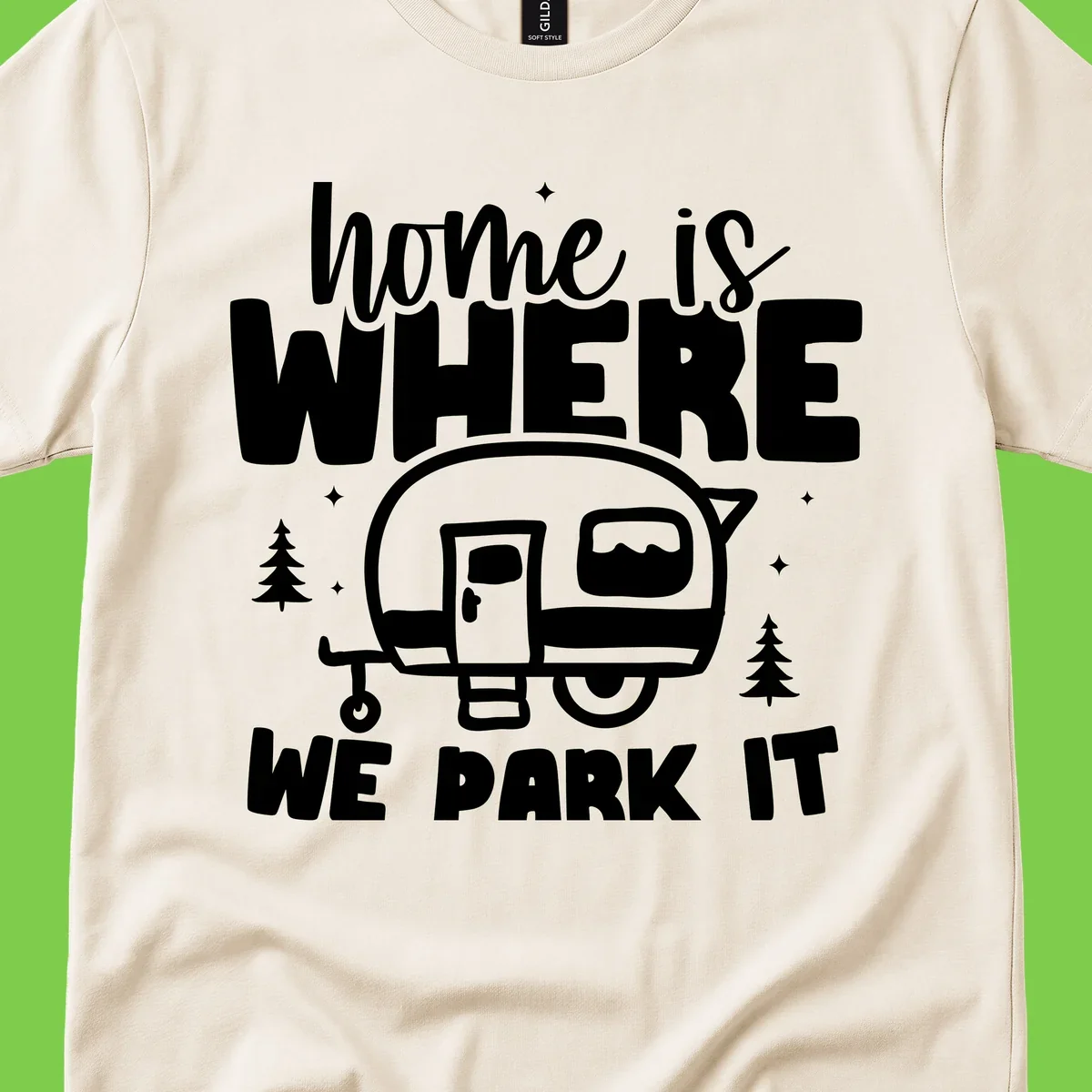 Retro-style design with 'home is where we park it' text and vintage travel trailer illustration surrounded by pine trees and sparkles
