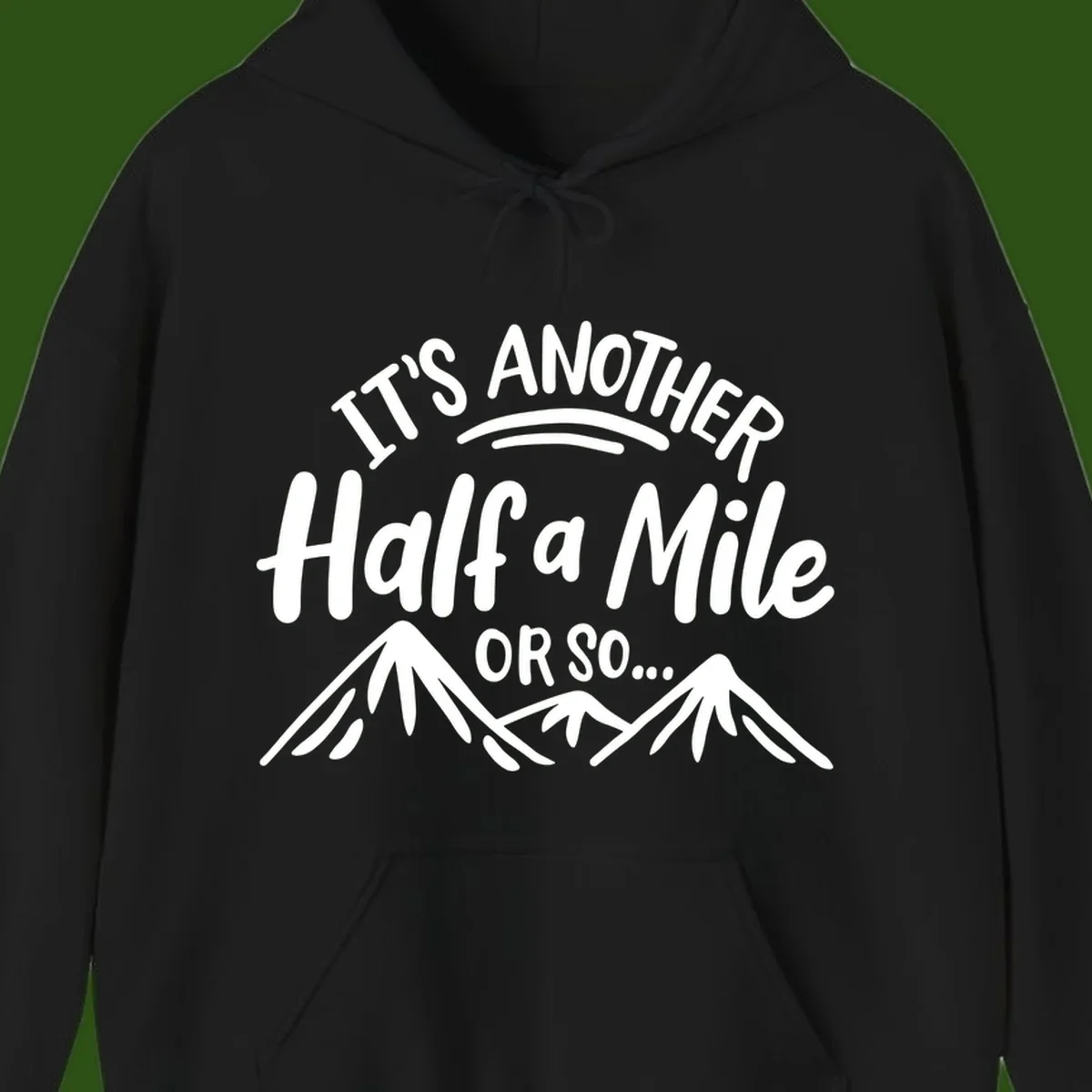 White text reading 'It's Another Half a Mile Or So...' with illustrated snow-capped mountains below on gray background