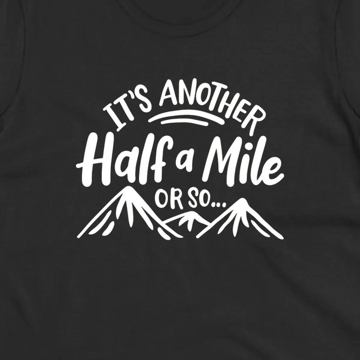 White text reading 'It's Another Half a Mile Or So...' with illustrated snow-capped mountains below on gray background