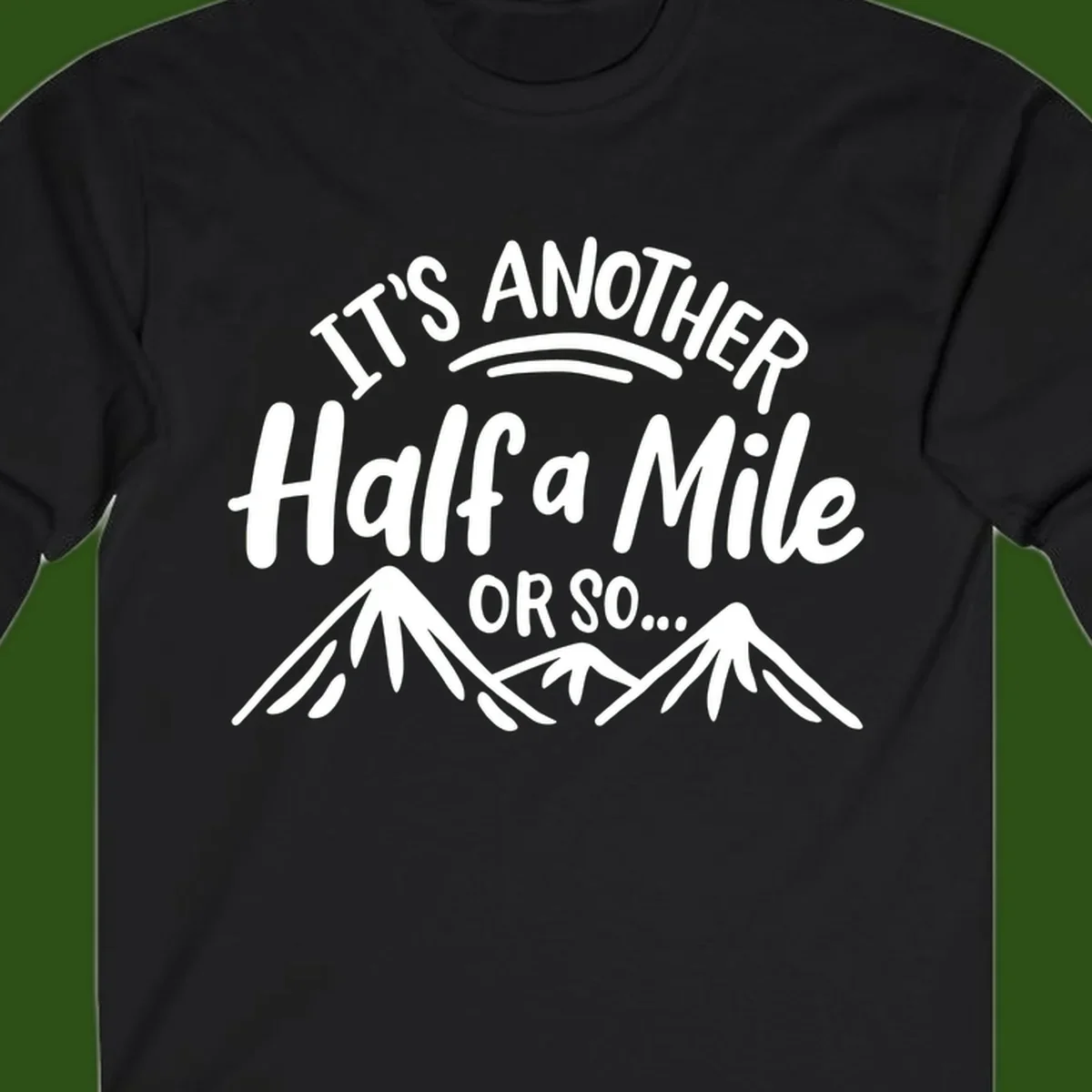 White text reading 'It's Another Half a Mile Or So...' with illustrated snow-capped mountains below on gray background