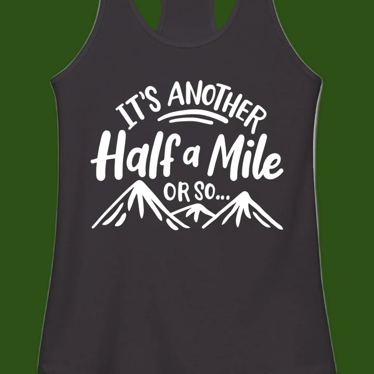 White text reading 'It's Another Half a Mile Or So...' with illustrated snow-capped mountains below on gray background