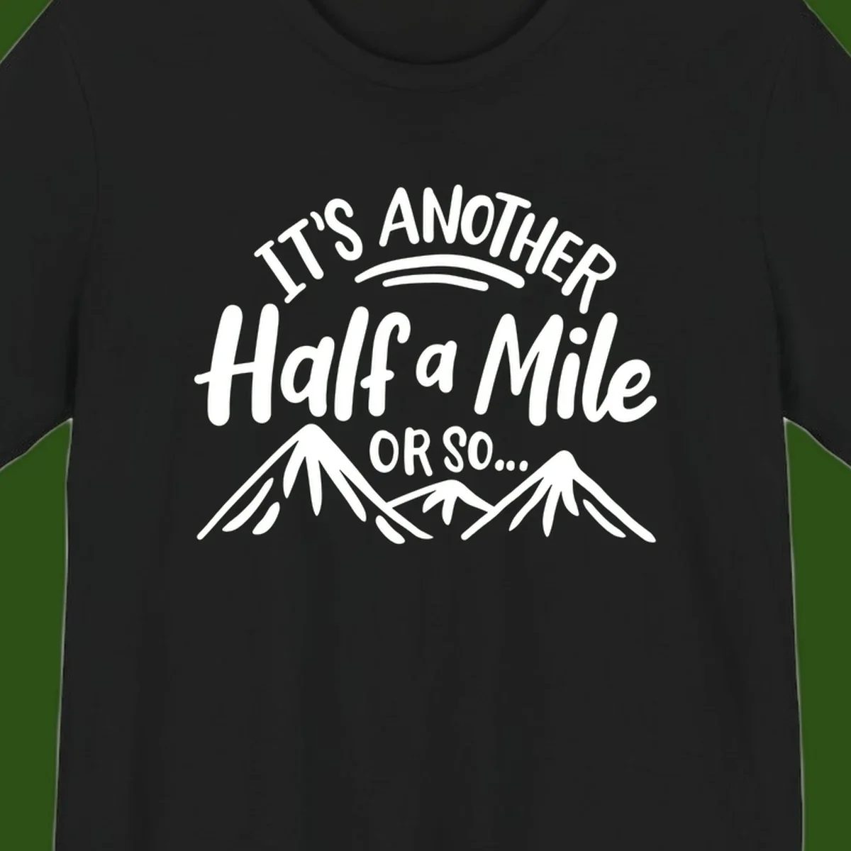 White text reading 'It's Another Half a Mile Or So...' with illustrated snow-capped mountains below on gray background