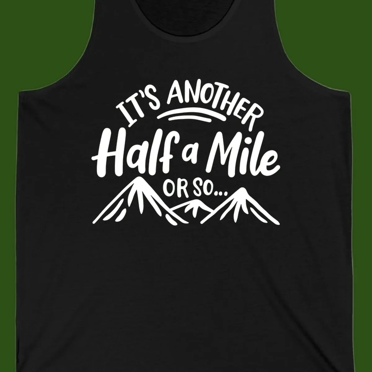 White text reading 'It's Another Half a Mile Or So...' with illustrated snow-capped mountains below on gray background