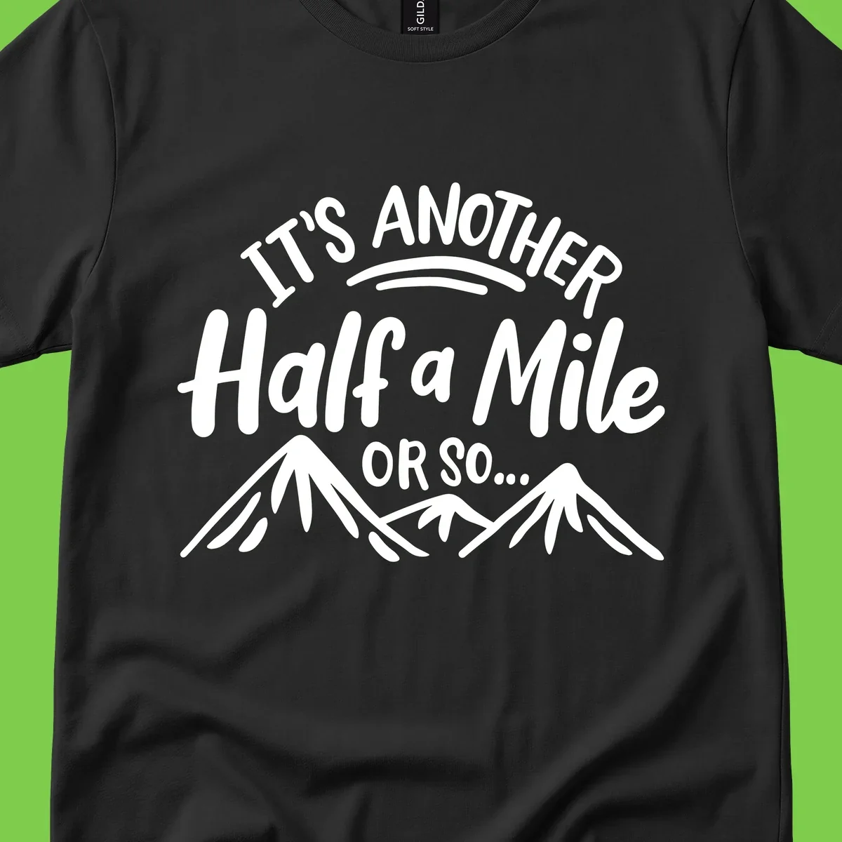 White text reading 'It's Another Half a Mile Or So...' with illustrated snow-capped mountains below on gray background