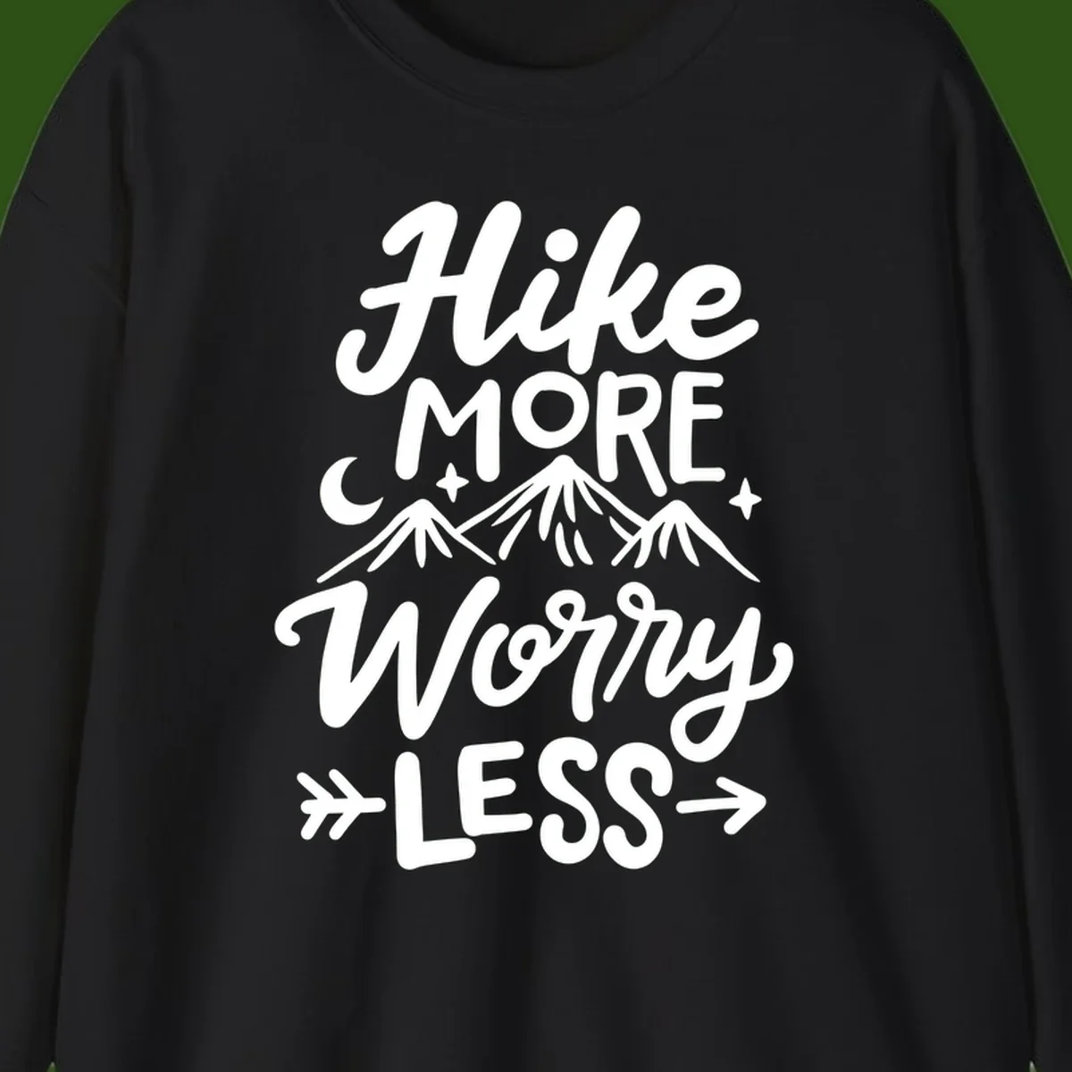 White lettered design reading 'Hike More Worry Less' with mountain peaks, moon, and stars on gray background