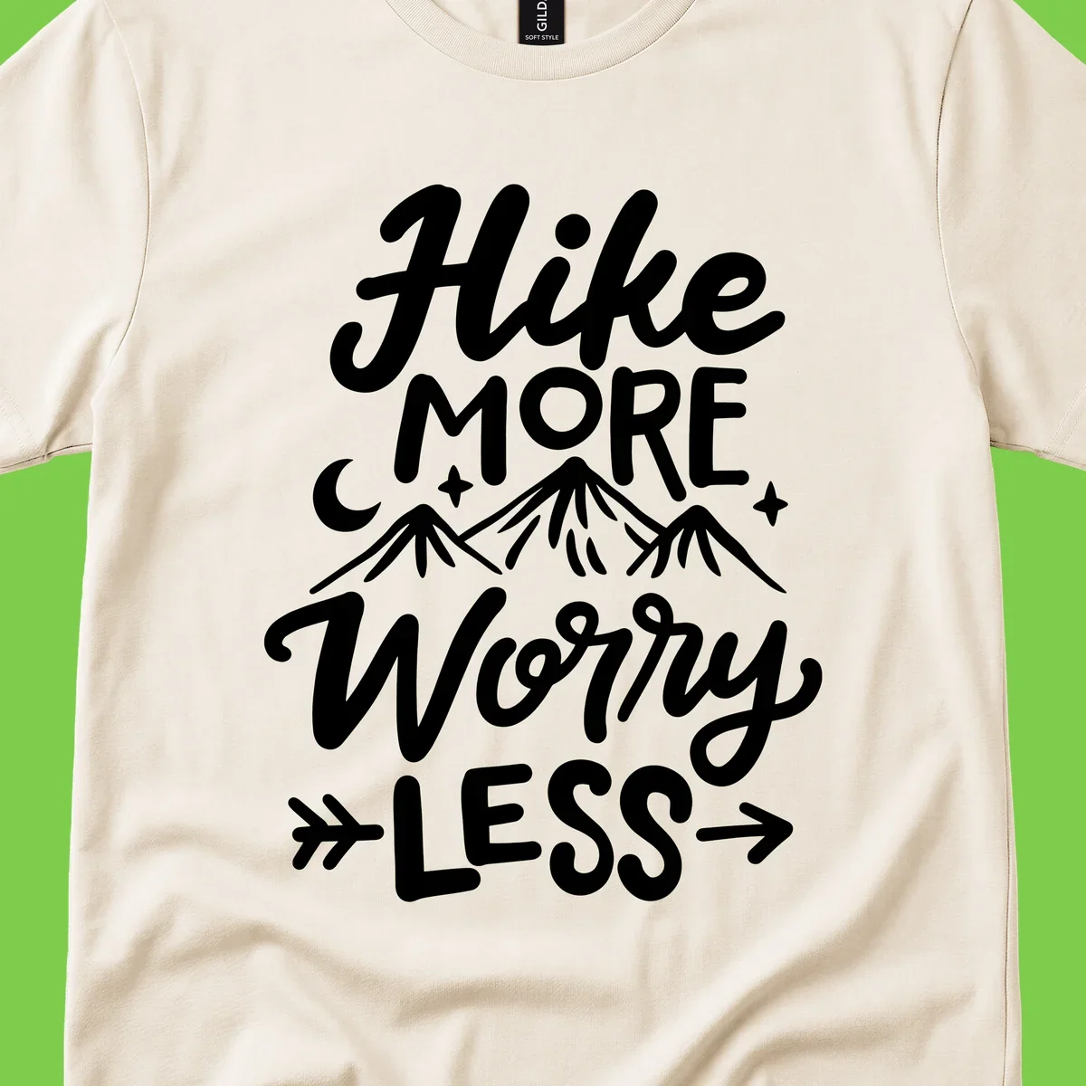 White lettered design reading 'Hike More Worry Less' with mountain peaks, moon, and stars on gray background