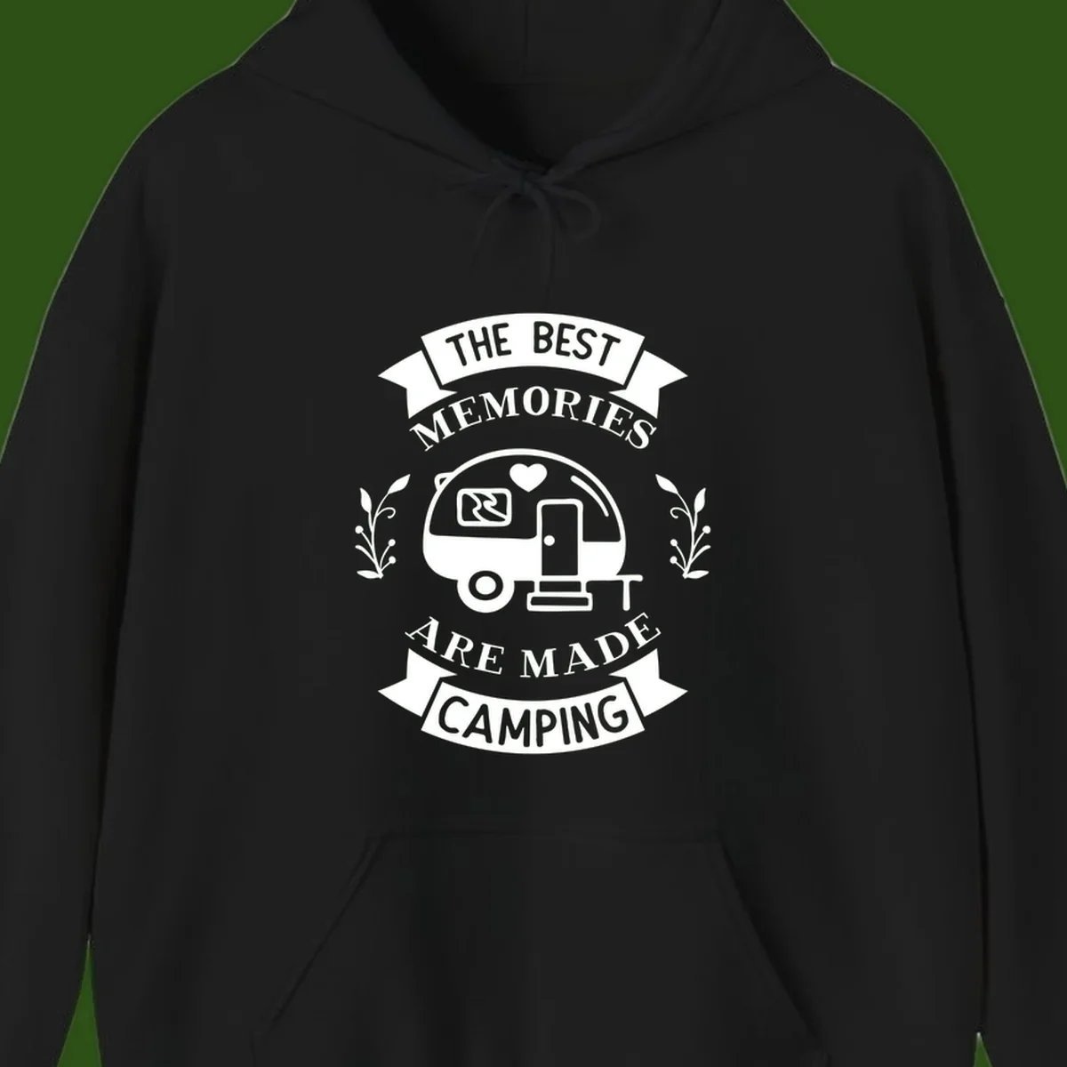 Vintage badge design with travel trailer and heart, text reading 'The Best Memories Are Made Camping' with decorative botanical branches