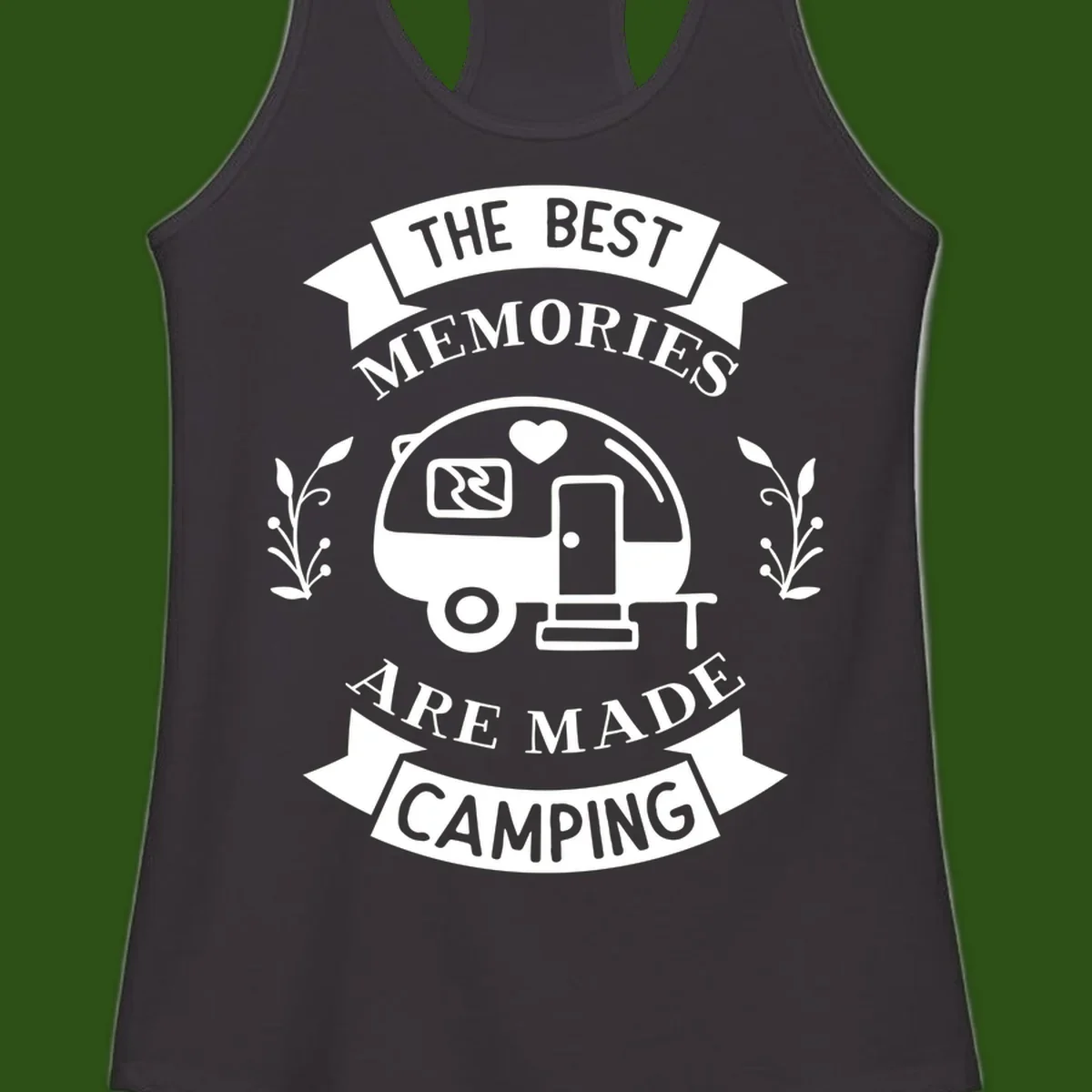 Vintage badge design with travel trailer and heart, text reading 'The Best Memories Are Made Camping' with decorative botanical branches