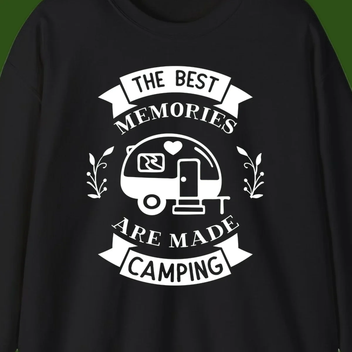 Vintage badge design with travel trailer and heart, text reading 'The Best Memories Are Made Camping' with decorative botanical branches
