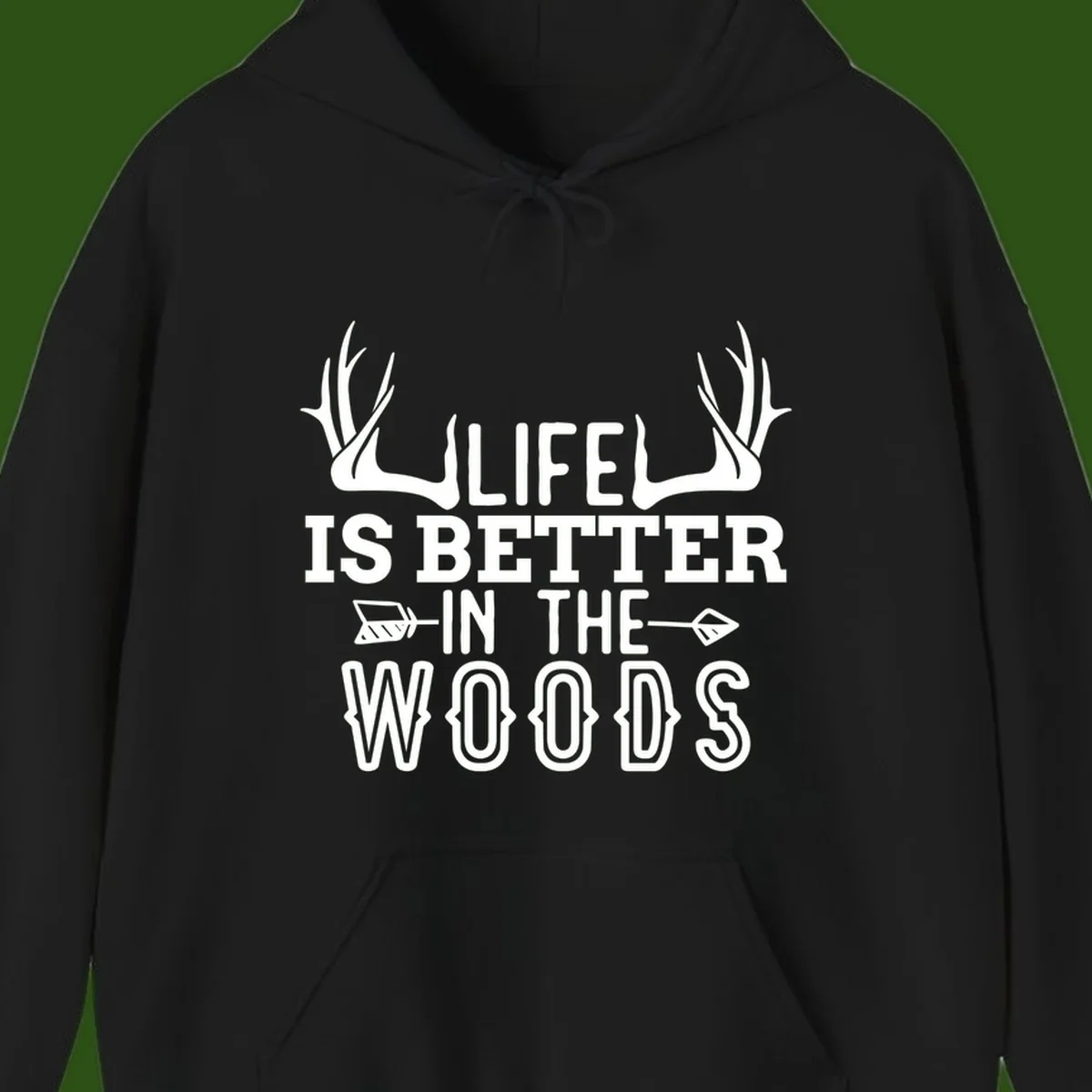 White text reading 'Life Is Better In The Woods' with deer antlers and arrows on gray background