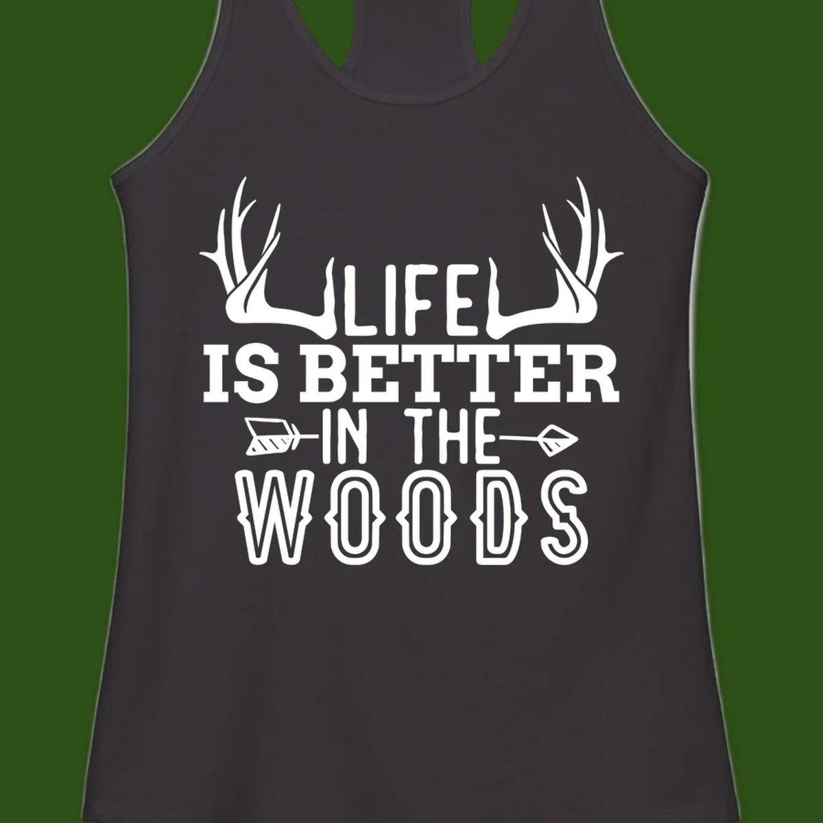 White text reading 'Life Is Better In The Woods' with deer antlers and arrows on gray background