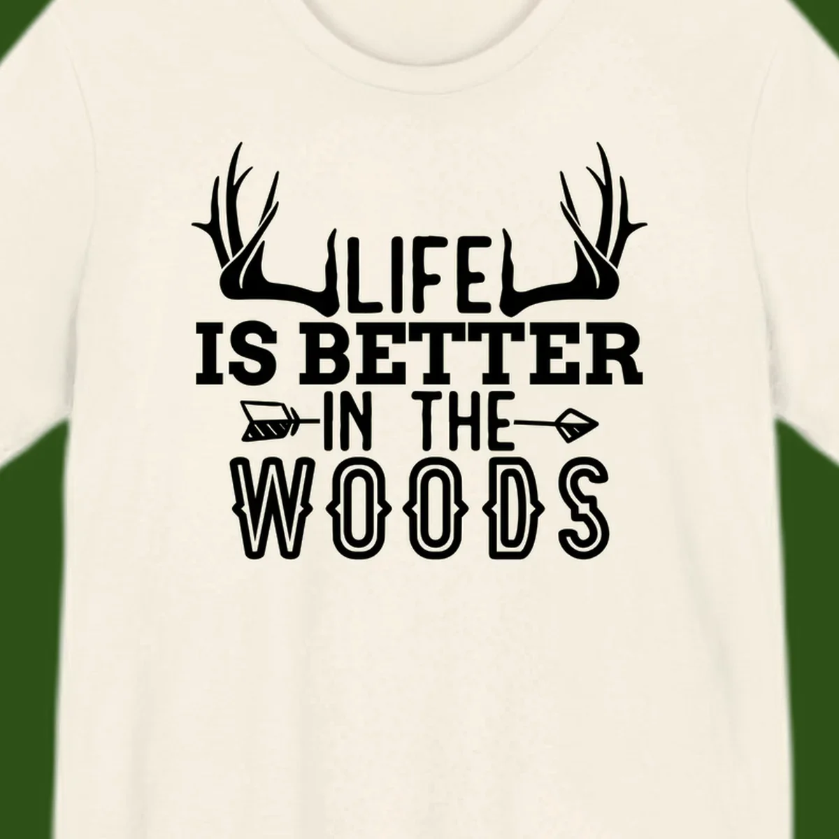White text reading 'Life Is Better In The Woods' with deer antlers and arrows on gray background