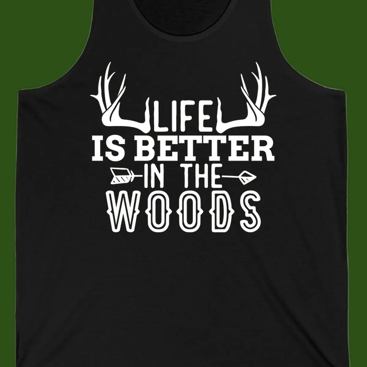 White text reading 'Life Is Better In The Woods' with deer antlers and arrows on gray background