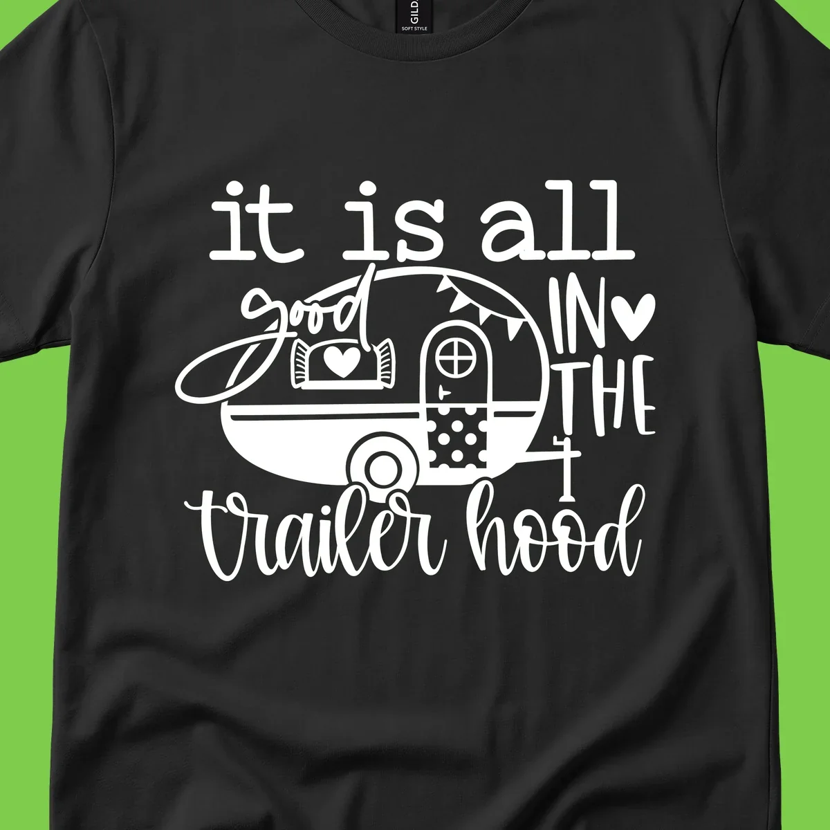 Vintage trailer illustration with decorative hearts and bunting, text reading 'it is all good in the trailer hood' in retro style