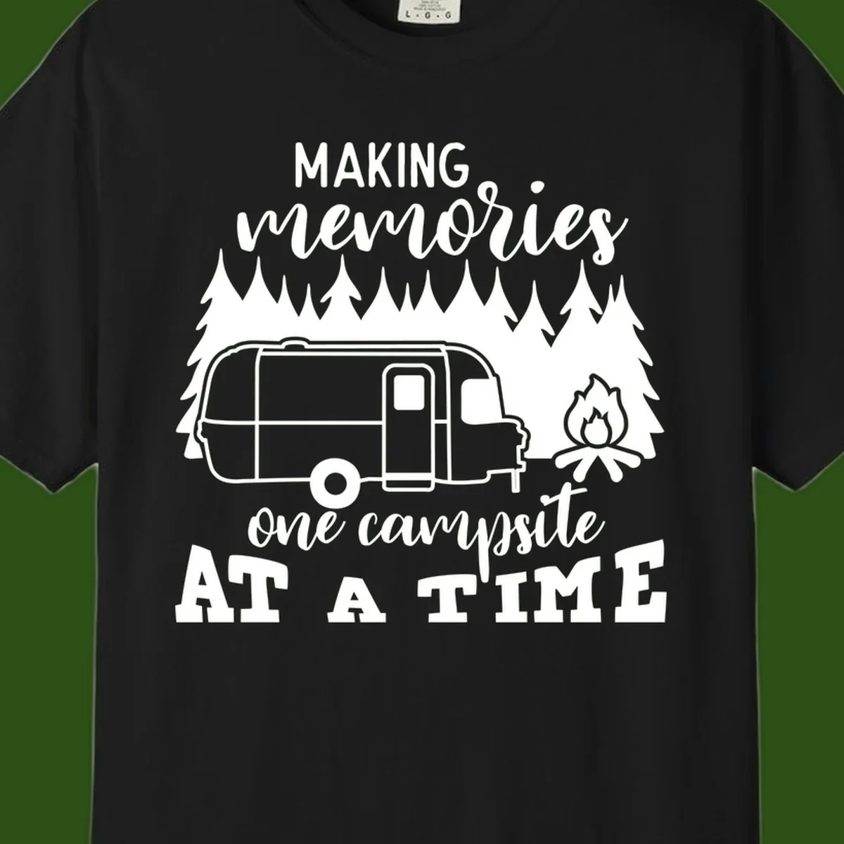 Vintage Airstream trailer parked among evergreen trees with a campfire, text reading Making Memories One Campsite At A Time