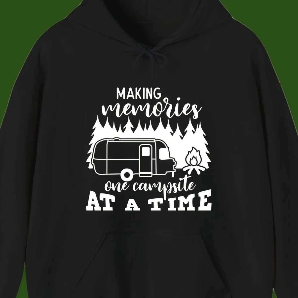 Vintage Airstream trailer parked among evergreen trees with a campfire, text reading Making Memories One Campsite At A Time