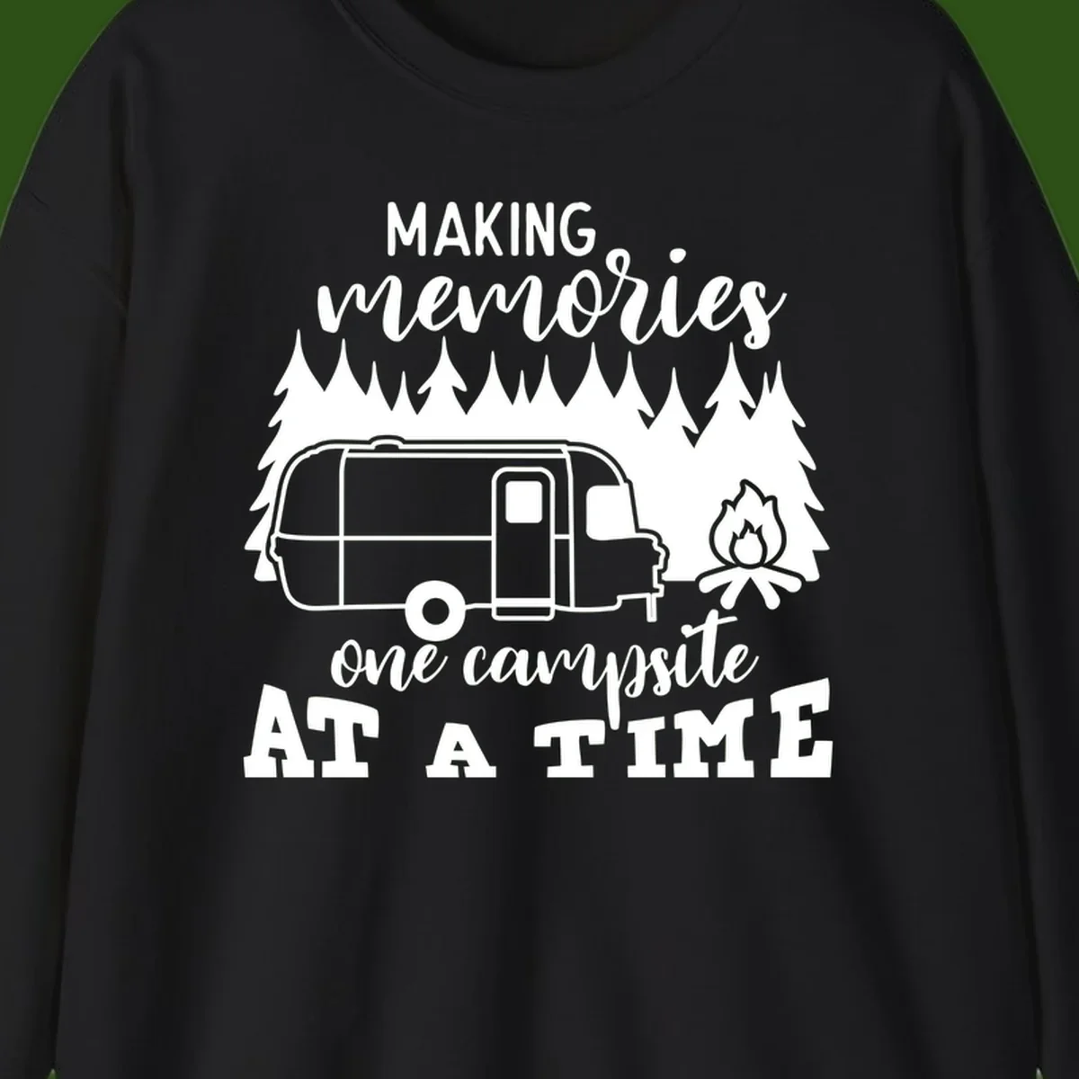 Vintage Airstream trailer parked among evergreen trees with a campfire, text reading Making Memories One Campsite At A Time