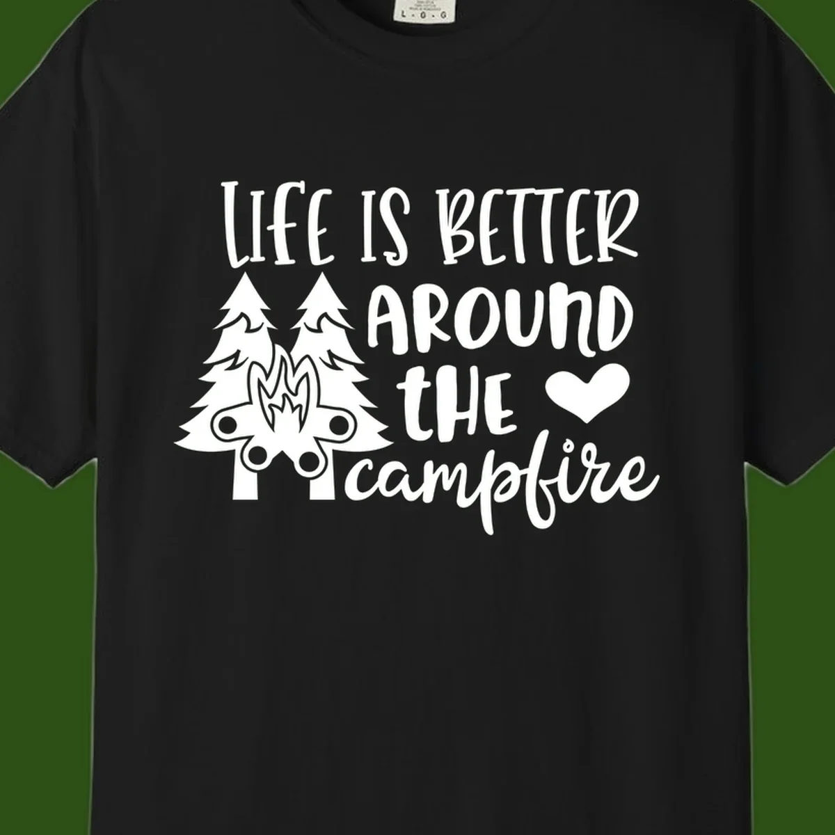 Hand-lettered design with pine trees, campfire, and heart reading 'Life Is Better Around The Campfire' on gray background