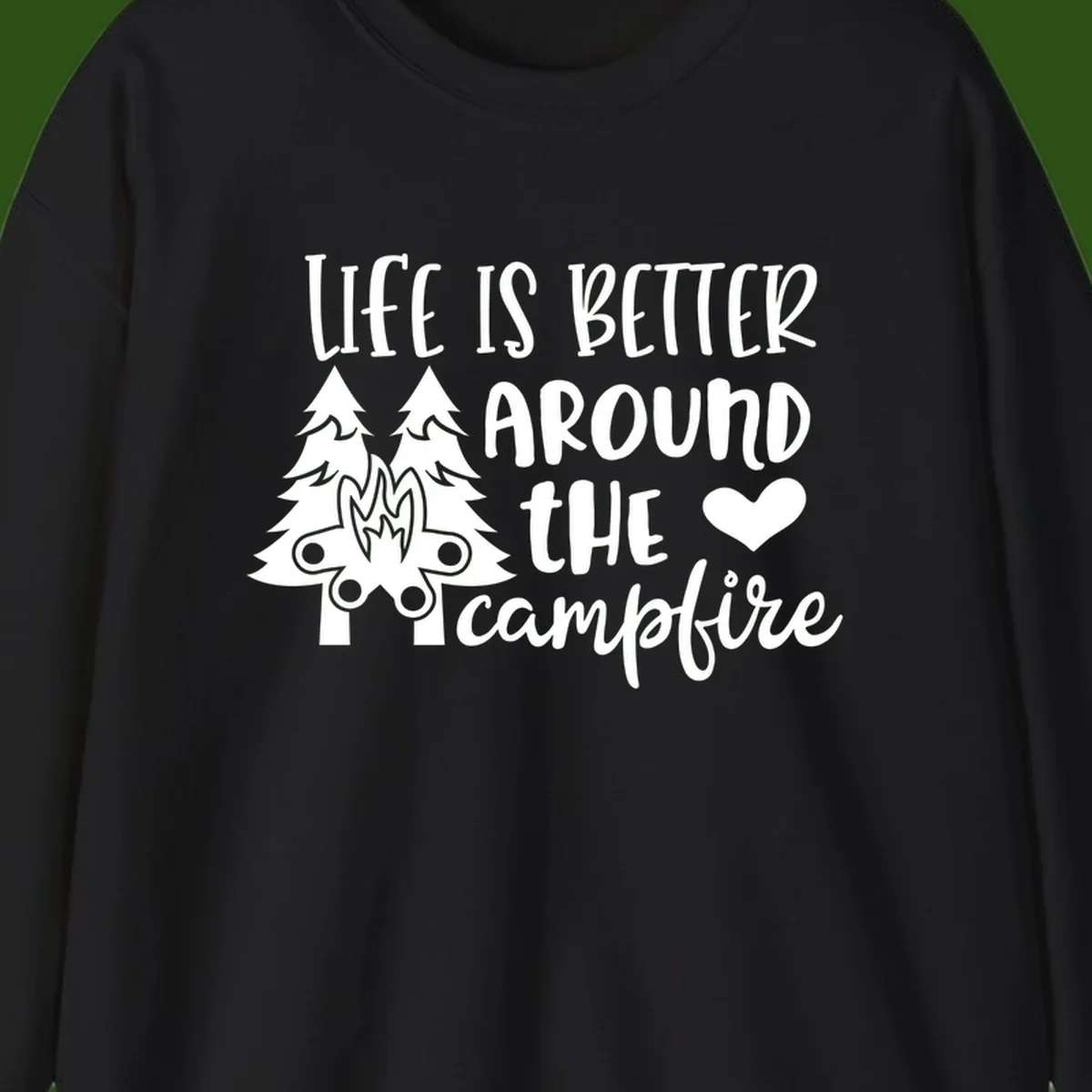 Hand-lettered design with pine trees, campfire, and heart reading 'Life Is Better Around The Campfire' on gray background