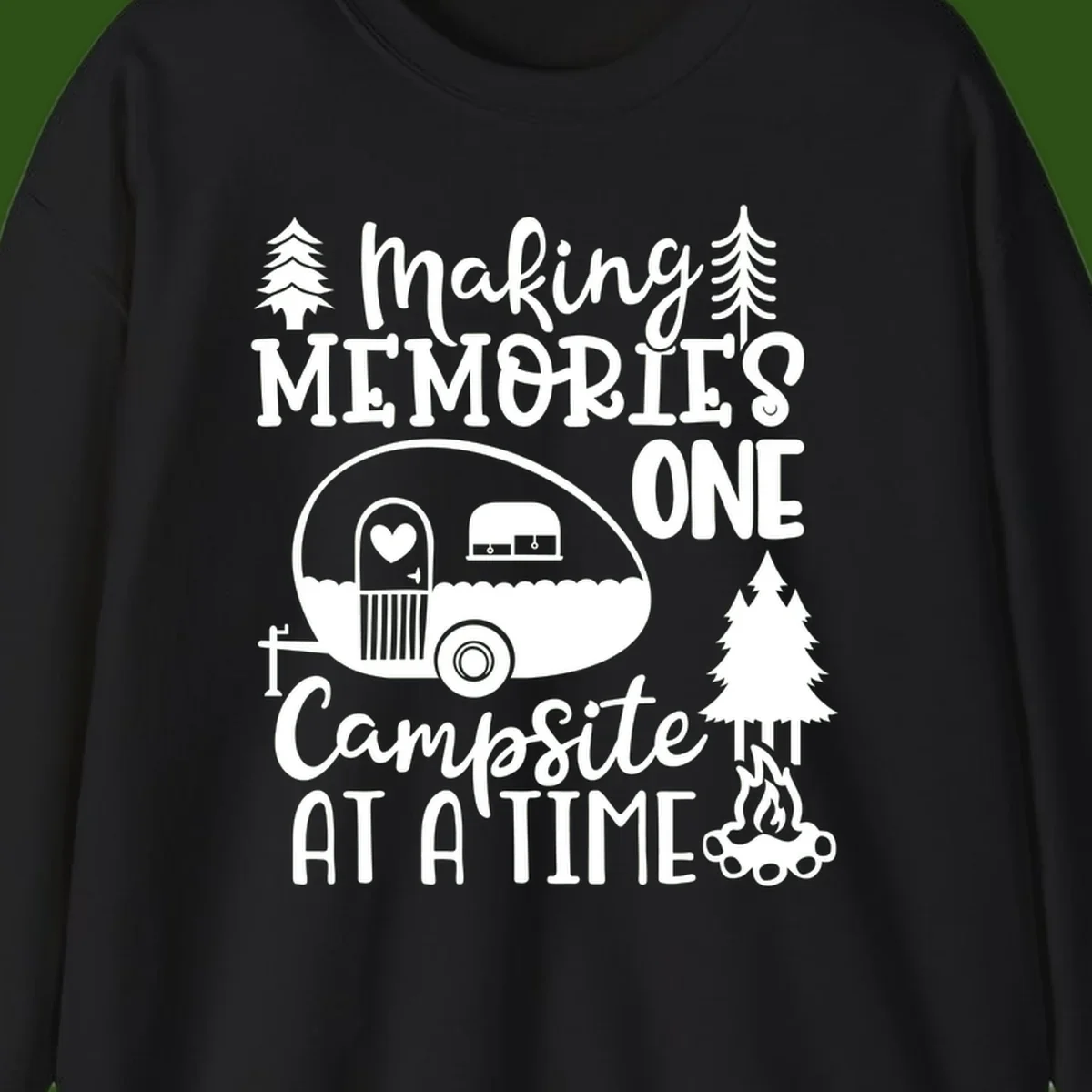 Vintage camper trailer surrounded by pine trees and campfire with 'Making Memories One Campsite At A Time' text