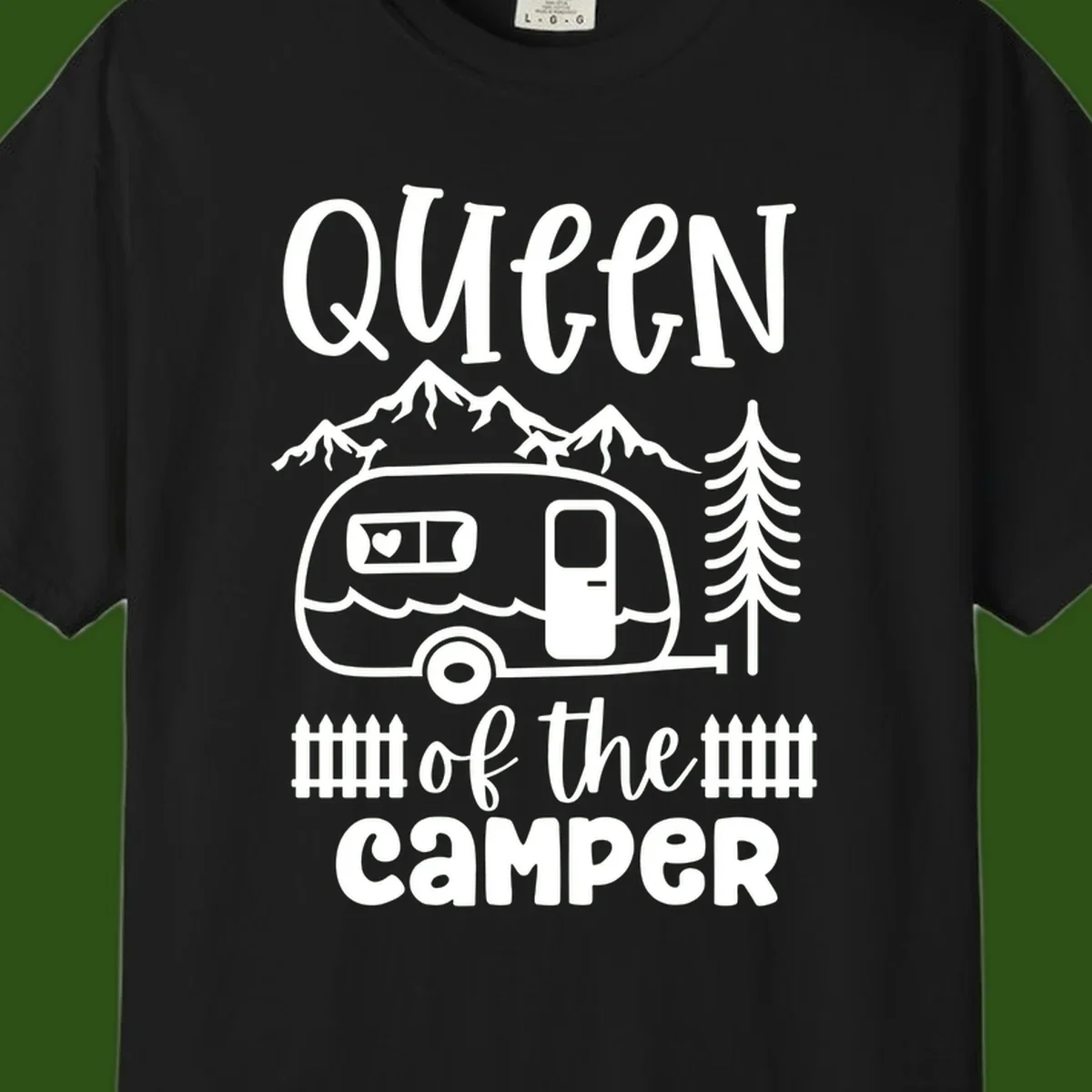 Queen of the Camper design featuring vintage trailer, mountains, and evergreen trees with bold text
