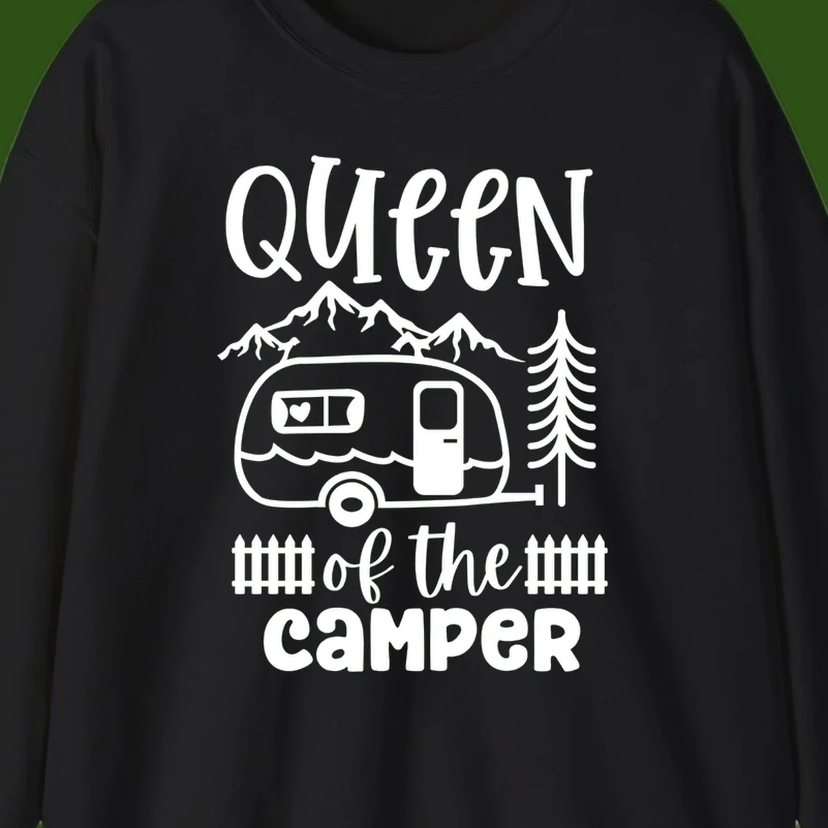 Queen of the Camper design featuring vintage trailer, mountains, and evergreen trees with bold text