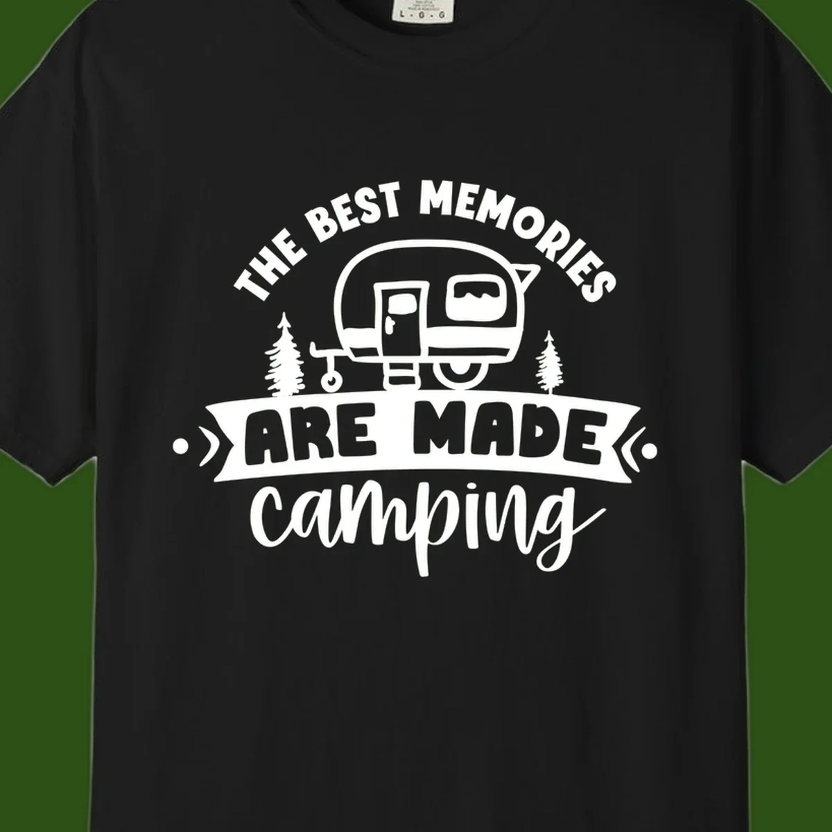 Vintage badge design with classic travel trailer, pine trees, and text reading 'The Best Memories Are Made Camping' in retro style.