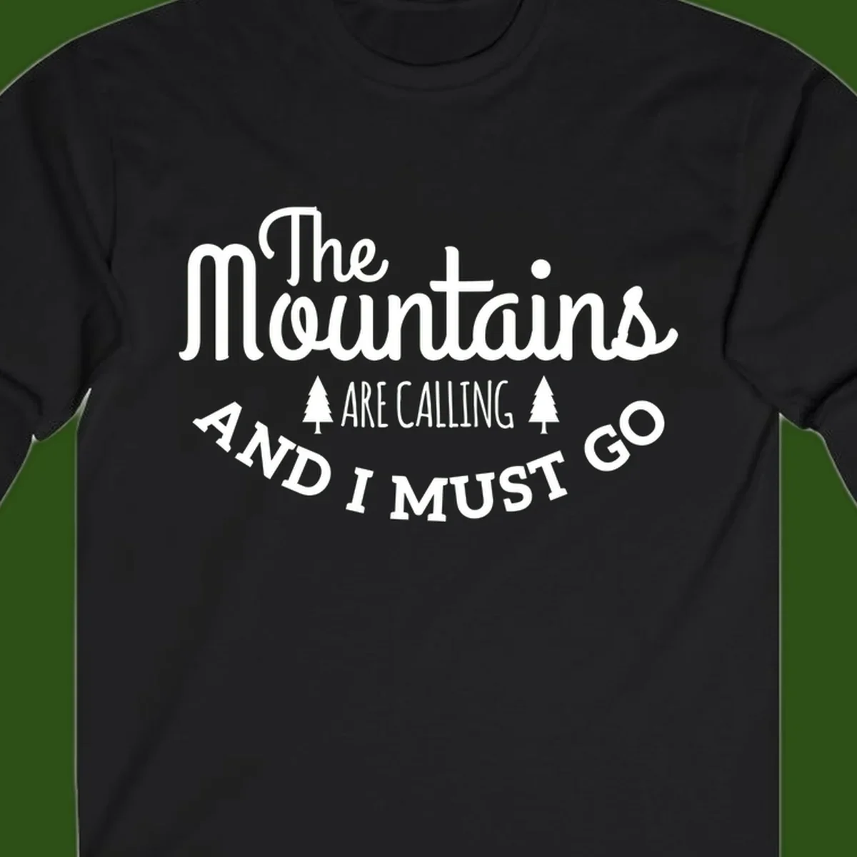 White text reading "The Mountains Are Calling And I Must Go" with pine trees on gray background