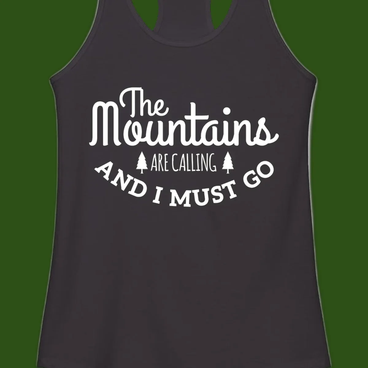 White text reading "The Mountains Are Calling And I Must Go" with pine trees on gray background