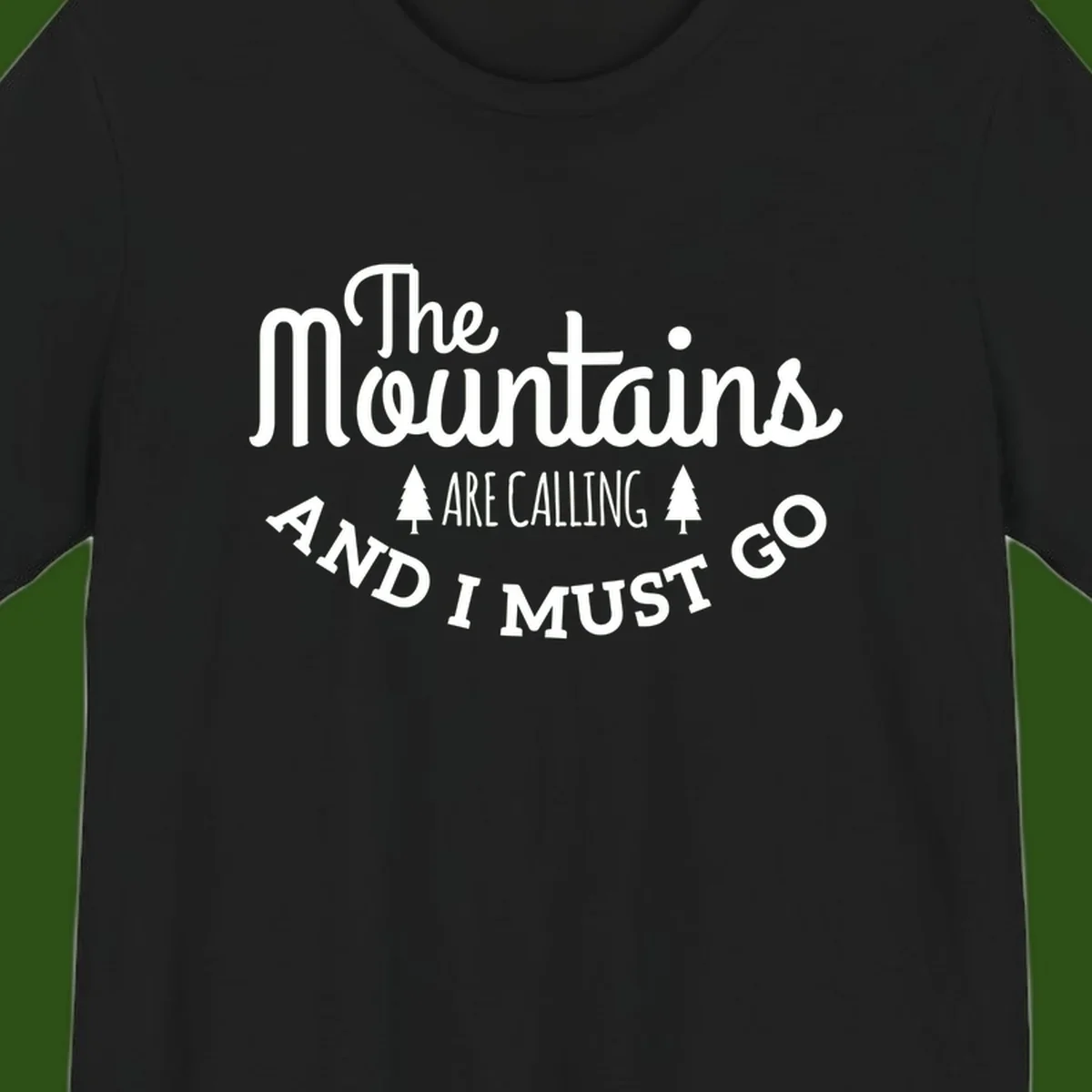 White text reading "The Mountains Are Calling And I Must Go" with pine trees on gray background