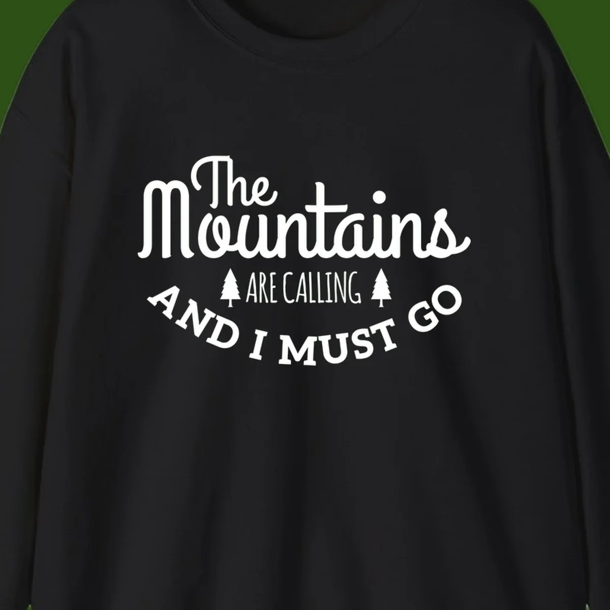 White text reading "The Mountains Are Calling And I Must Go" with pine trees on gray background
