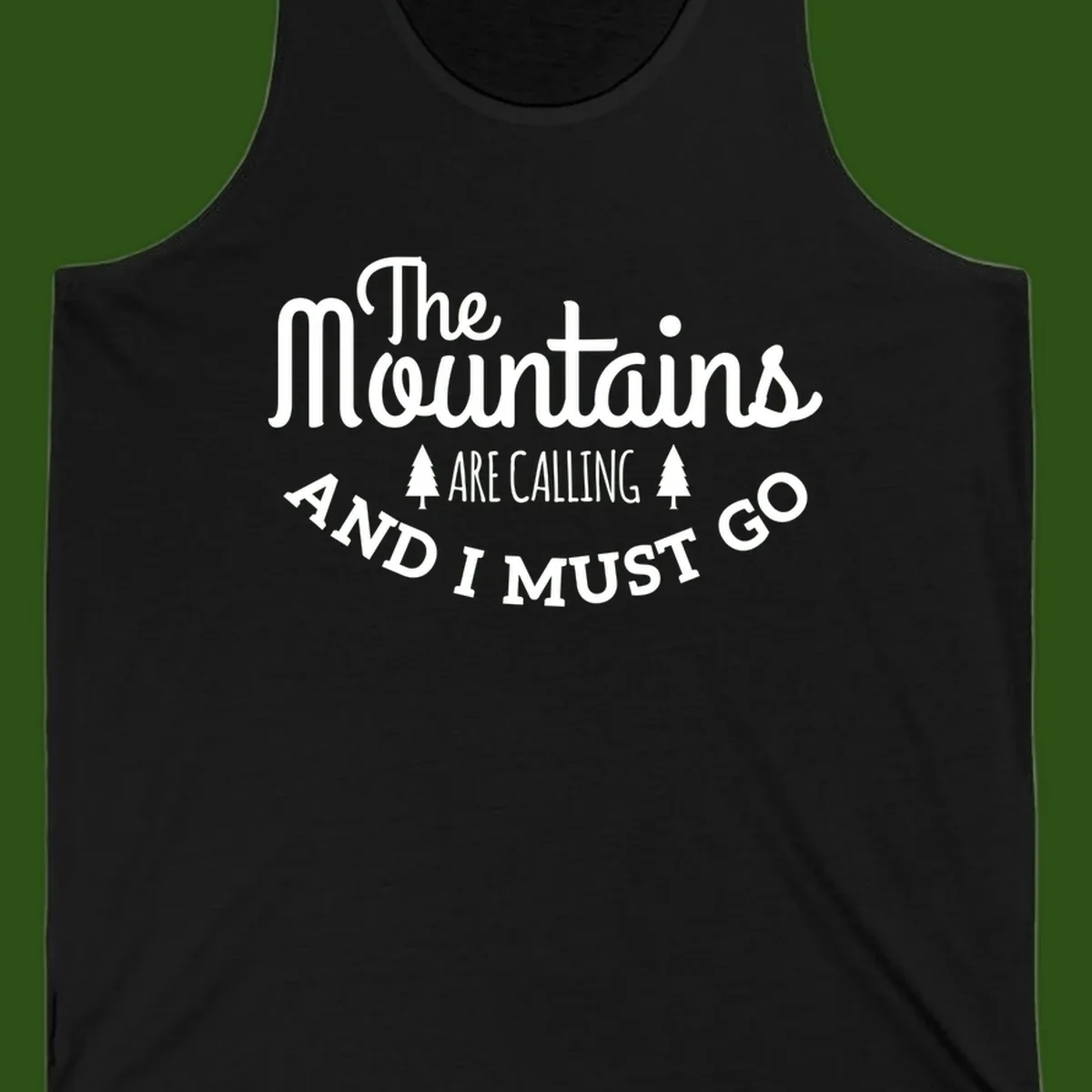 White text reading "The Mountains Are Calling And I Must Go" with pine trees on gray background