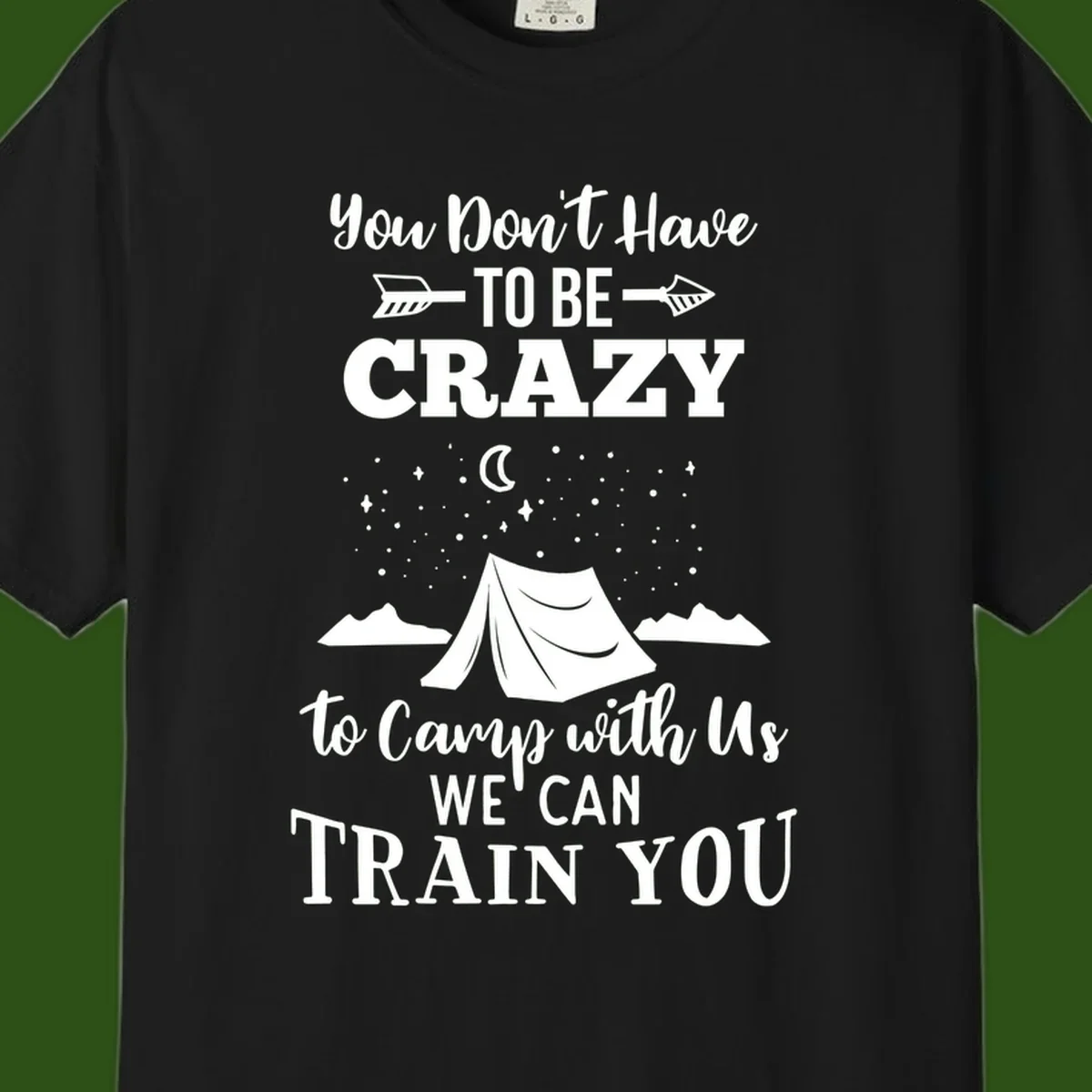 Gray design with white text reading 'You Don't Have To Be Crazy To Camp With Us We Can Train You' featuring a tent under stars and mountains