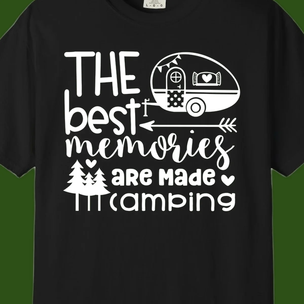 Vintage travel trailer with decorative text reading 'The best memories are made camping' surrounded by pine trees and hearts on gray background.