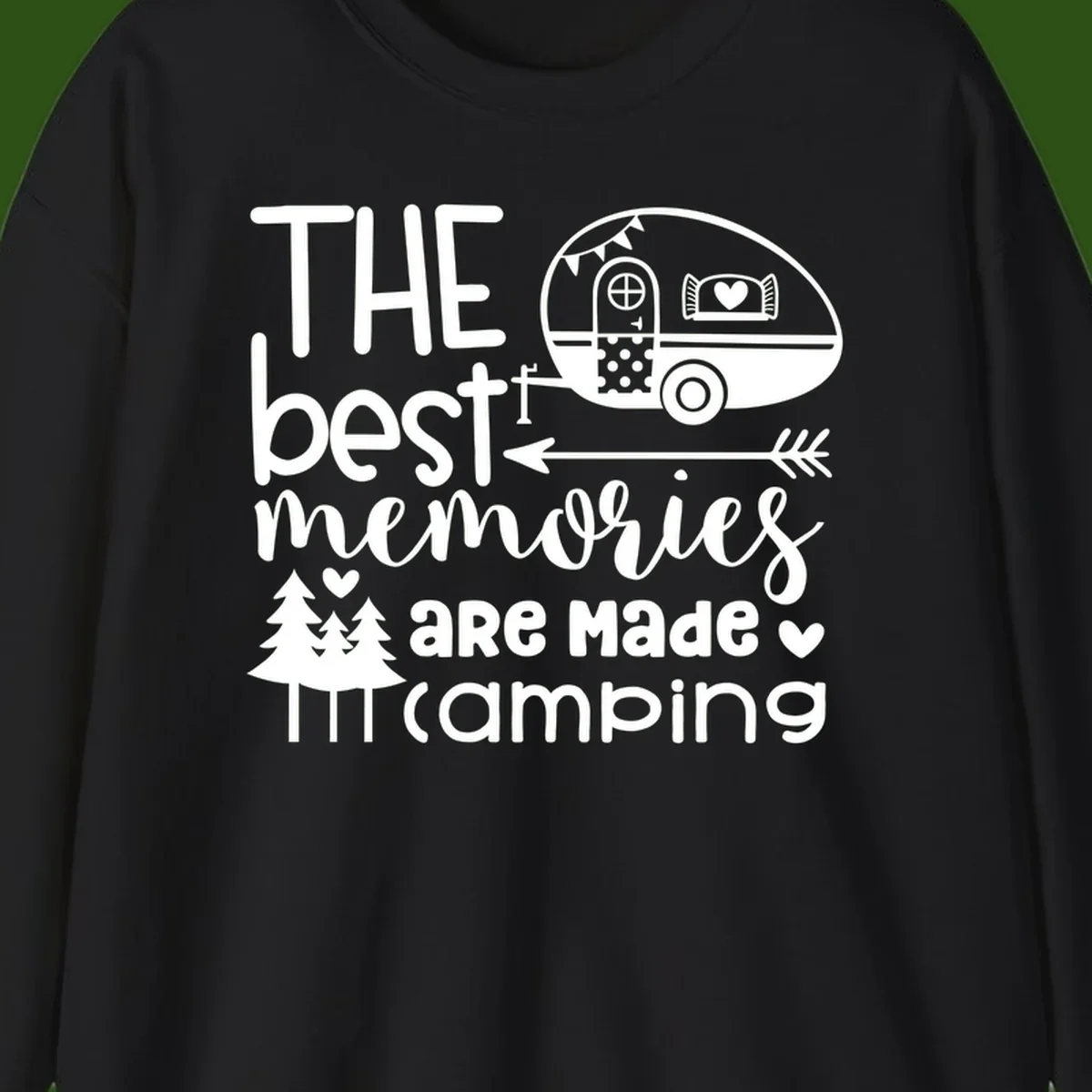 Vintage travel trailer with decorative text reading 'The best memories are made camping' surrounded by pine trees and hearts on gray background.