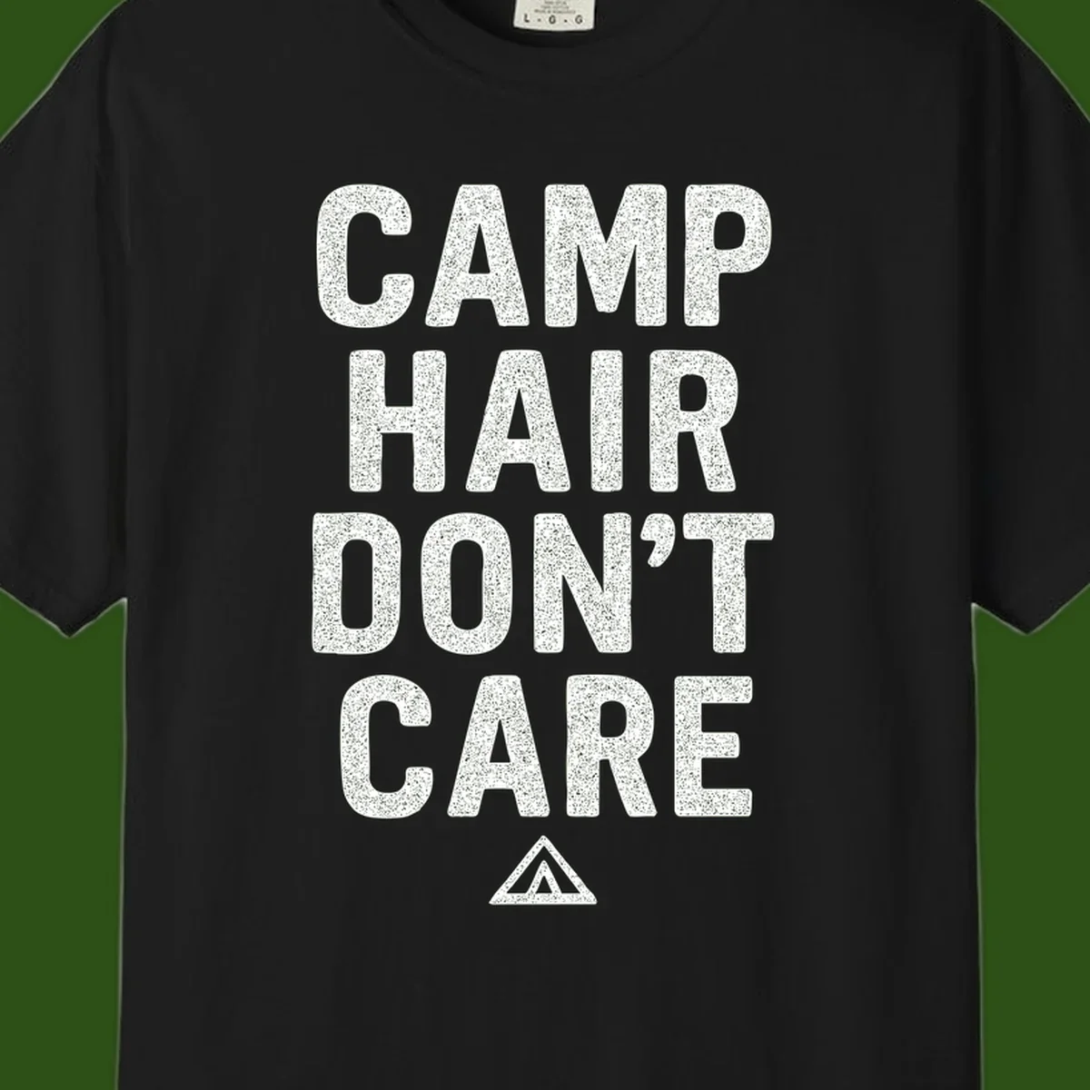 White speckled text reading 'Camp Hair Don't Care' with triangle symbol on gray background