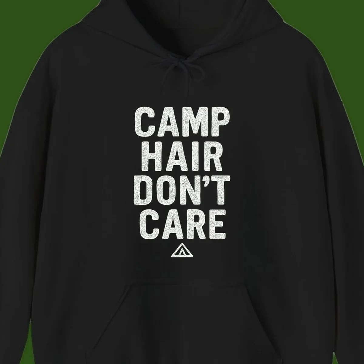 White speckled text reading 'Camp Hair Don't Care' with triangle symbol on gray background