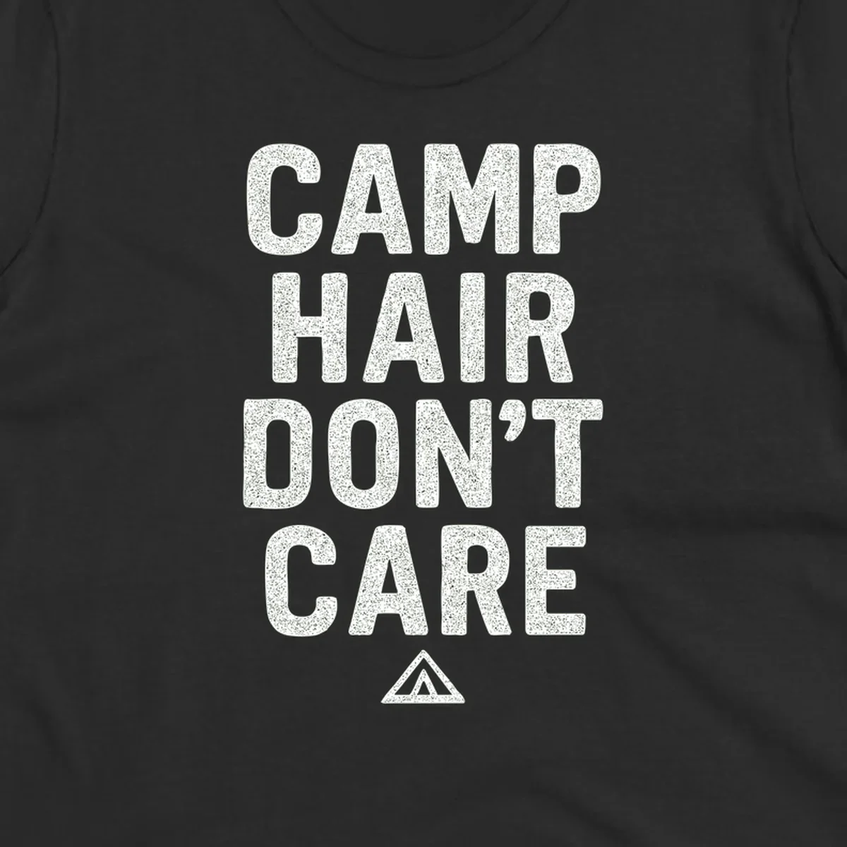 White speckled text reading 'Camp Hair Don't Care' with triangle symbol on gray background
