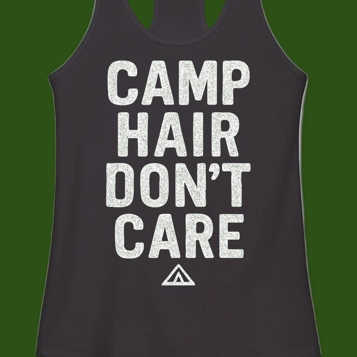 White speckled text reading 'Camp Hair Don't Care' with triangle symbol on gray background