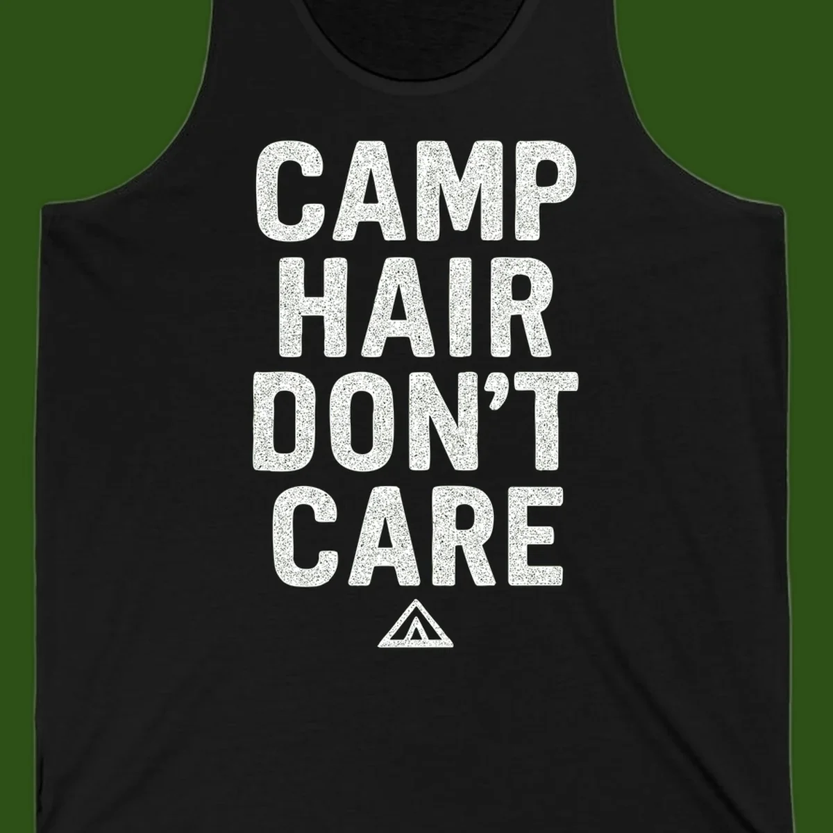 White speckled text reading 'Camp Hair Don't Care' with triangle symbol on gray background